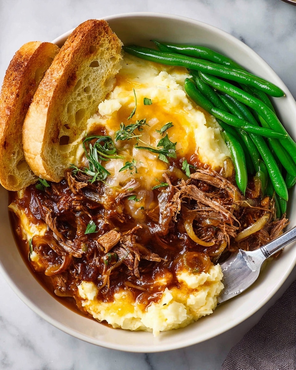 In a white bowl on a white marbled surface, there is a dish with four main layers. The bottom left layer is creamy mashed potatoes with a soft, smooth texture and pale yellow color. On top of the mashed potatoes and spreading slightly into the center is a rich, dark brown onion gravy with visible cooked onion slices. The center and right side have shredded brown meat covered with melted light yellow cheese and garnished with sprigs of fresh green herbs. On the top right side of the bowl are bright green cooked green beans, and on the top left side are two toasted slices of golden brown bread. A knife rests partially inside the bowl, touching the mashed potatoes. photo taken with an iphone --ar 4:5 --v 7