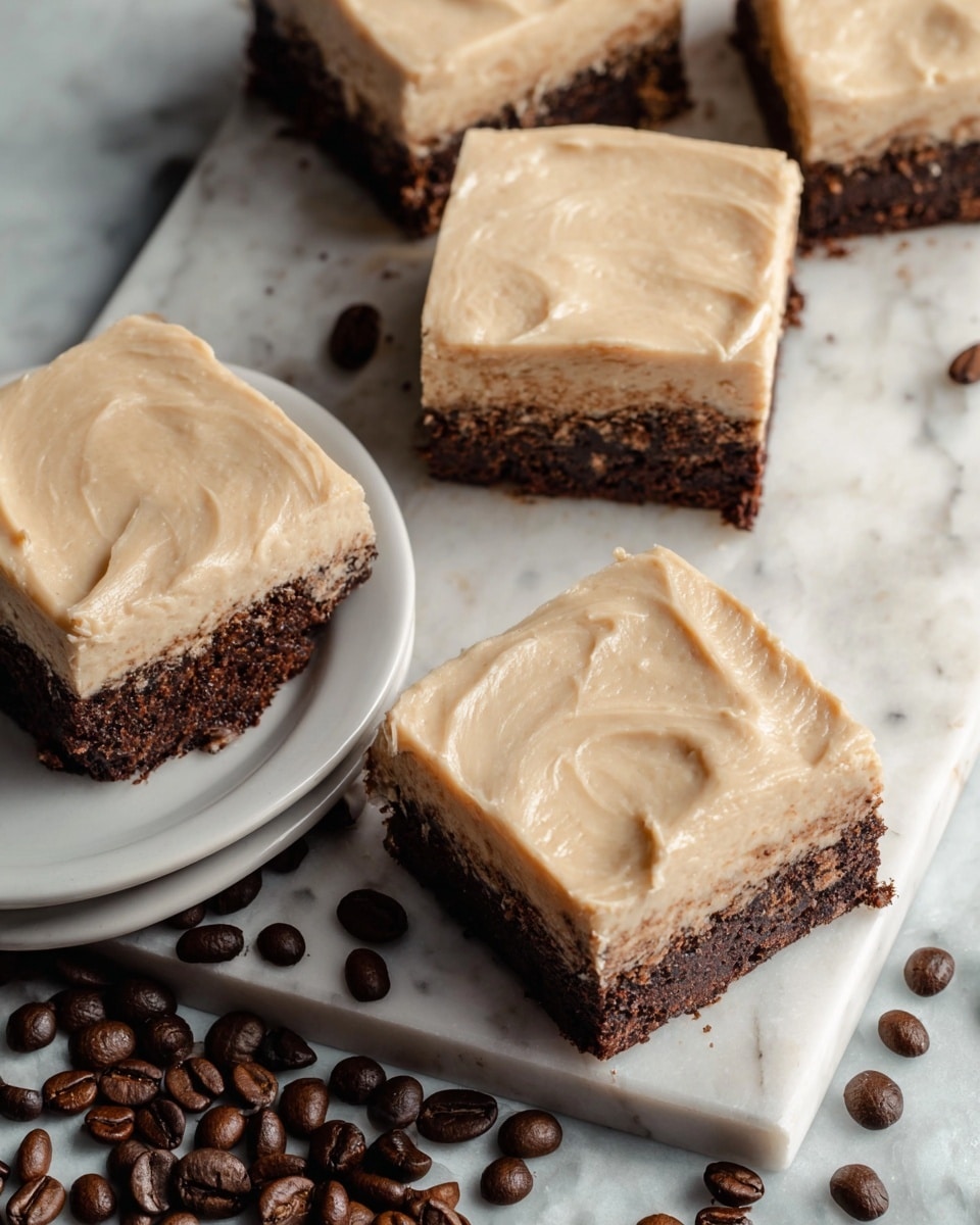 The image shows four square pieces of dessert with two distinct layers: a thicker bottom layer with a dark brown, slightly crumbly texture, and a smooth, light beige frosting layer on top. Three pieces rest on a white round plate at the left side, and one piece is placed directly on a white marbled surface to the right, surrounded by scattered dark brown coffee beans. The topping looks creamy and evenly spread with soft, visible swirls. Photo taken with an iphone --ar 4:5 --v 7