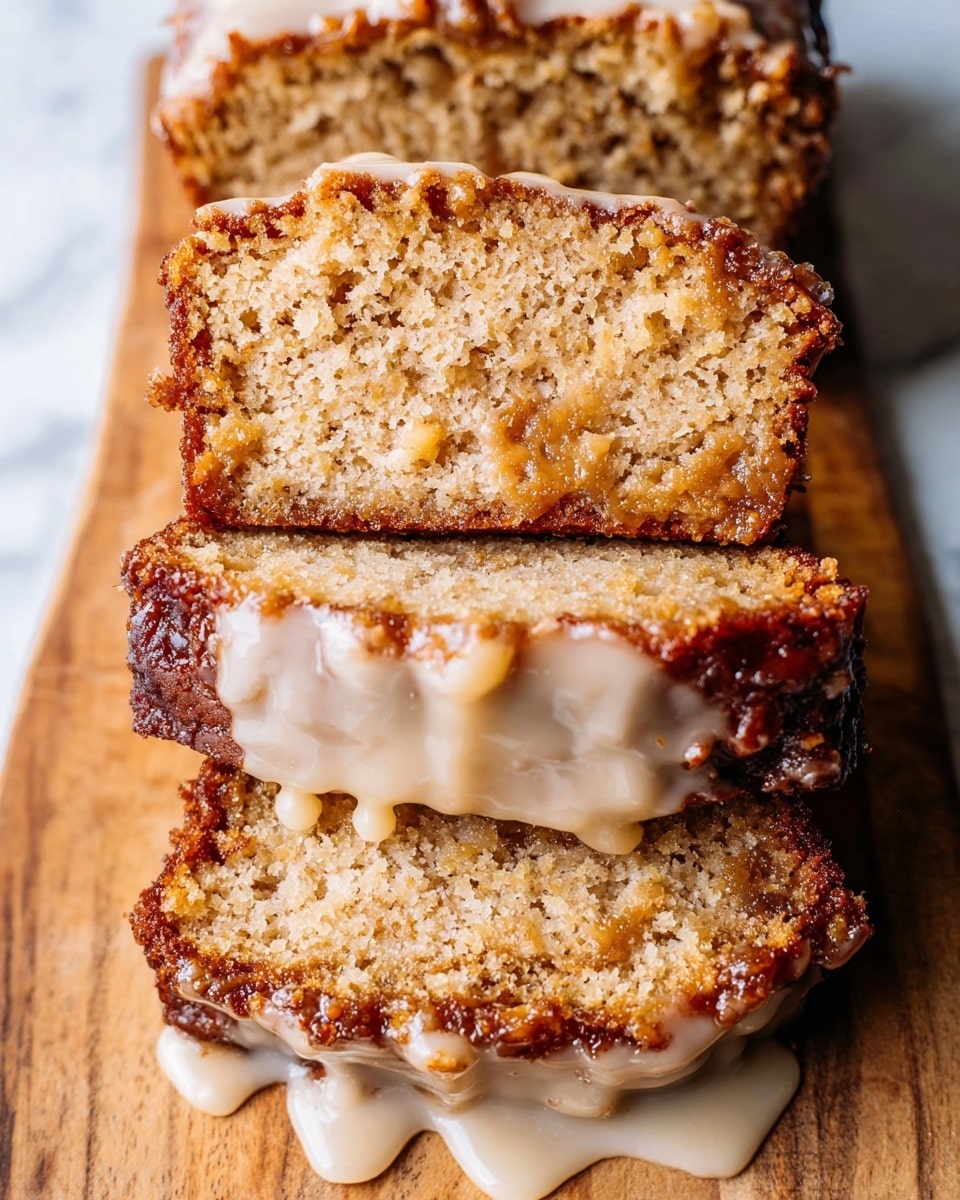 The image shows three slices of a light brown cake stacked on top of each other, each slice having a moist and slightly crumbly texture with small chunks inside. The bottom edges of the slices are darker and caramelized, giving a contrast to the lighter interior. The top slice has a thick layer of creamy, light tan glaze dripping down the sides. The cake slices rest on a wooden surface with a white marbled texture in the background. photo taken with an iphone --ar 4:5 --v 7