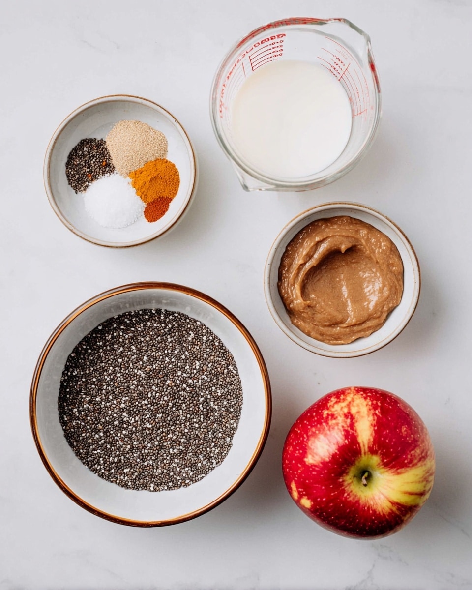 The image shows five separate white dishes and containers arranged on a white marbled surface. In the center, there is a white bowl with a brown rim filled with small, black chia seeds spread evenly. To the left, two smaller white bowls with brown rims hold ingredients: one has a set of various spices in brown, orange, and light tan shades beside a small pile of white salt, and the other contains a thick, smooth brown paste. To the top right, a clear glass measuring cup with red markings is filled almost to the top with white milk. At the bottom right, there is a shiny red apple with yellow-green spots resting directly on the white marbled surface. photo taken with an iphone --ar 4:5 --v 7