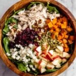 Fall Harvest Salad with Roasted Sweet Potatoes, Chicken, Apples, Cranberries, Pumpkin Seeds, and Goat Cheese Recipe