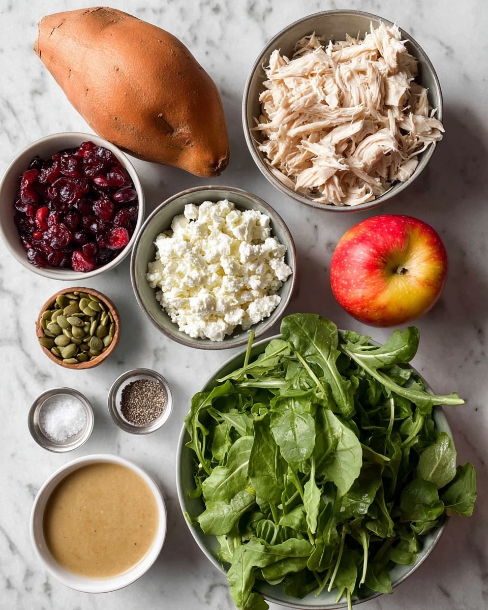 This image shows fresh ingredients for a salad on a white marbled surface. At the bottom right, there is a bowl full of green arugula leaves with rough edges and varied sizes. Above it, a bowl contains shredded pale beige cooked chicken with a fibrous texture. Next to the chicken, a smaller bowl holds green pumpkin seeds with a smooth, shiny surface. Above that, a bowl filled with crumbly white cottage cheese is visible. To the left of the cottage cheese, there is a bowl with deep red dried cranberries that look shiny and wrinkly. Below that, a small bowl contains coarse salt and cracked black pepper. On the bottom left side, a whole orange sweet potato sits beside a red and yellow apple with smooth skin. Lastly, at the bottom left corner, a small bowl holds a creamy light brown sauce with a smooth texture. The photo taken with an iphone --ar 4:5 --v 7