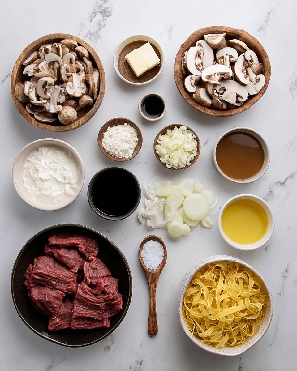 The image shows ingredients laid out on a white marbled surface for cooking a beef stroganoff dish. There are two wooden bowls with sliced mushrooms, one with white mushrooms and the other with brown mushrooms. Next to them are small wooden bowls with flour and butter. A black bowl holds thick white sour cream, while two white bowls contain brown broth. A smaller white bowl has soy sauce. There is a small wooden spoon filled with salt, another small white bowl with chopped garlic, and a small white bowl with yellow oil. Thinly sliced white onions are next to a pile of uncooked yellow egg noodles in a white bowl. In the center, a dark bowl holds raw beef cut into thick strips. Everything is neatly arranged and ready for cooking photo taken with an iphone --ar 4:5 --v 7