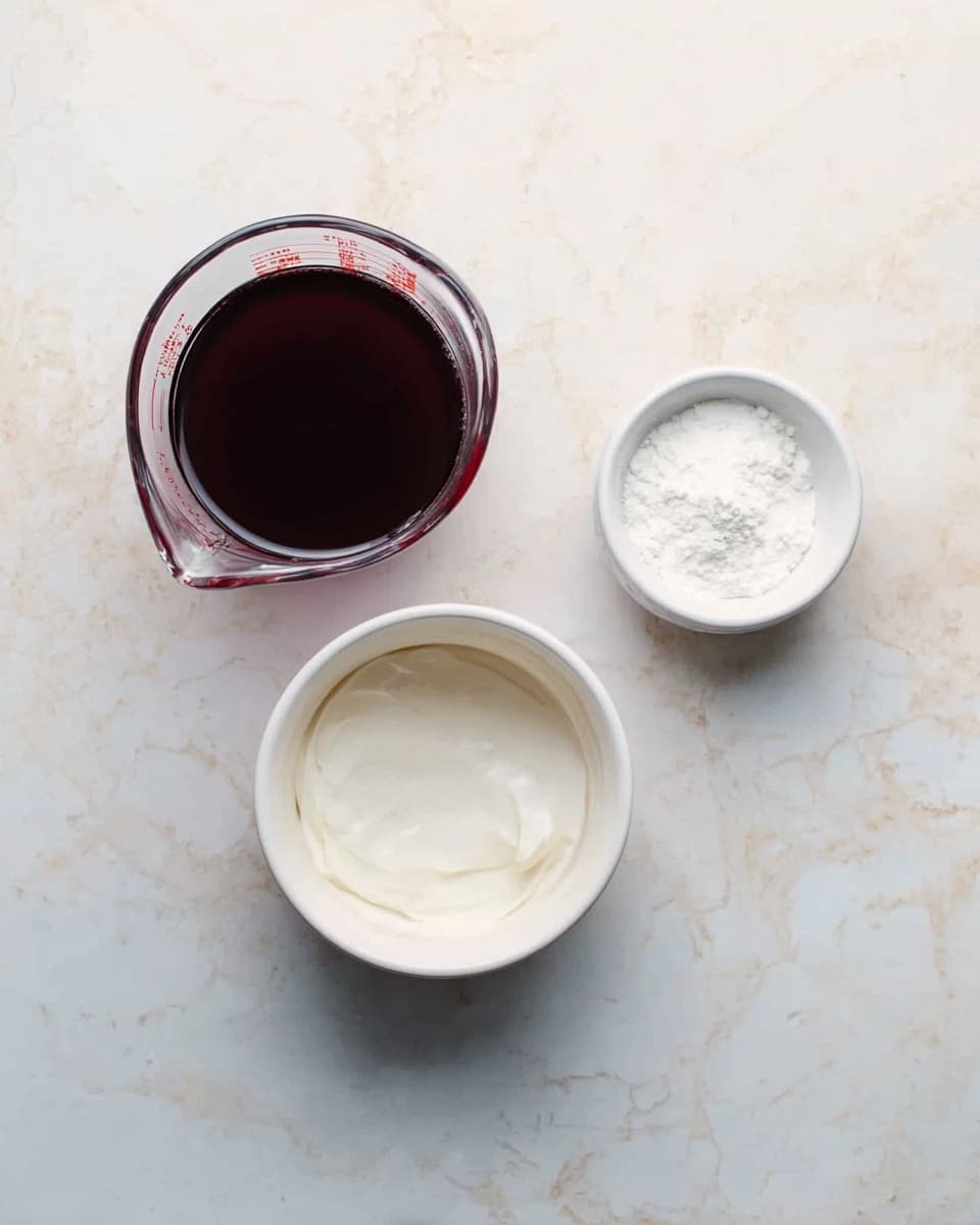The image shows three small containers on a white marbled surface. On the left is a clear glass measuring cup filled with a dark red liquid, smooth and shiny on top. To the right of it, near the top, is a small white bowl filled with a fine white powder. Below these two containers, there is a larger white bowl filled with a thick white substance that looks creamy and smooth. The arrangement is neat and spaced out, with soft lighting that highlights the different textures of the items. Photo taken with an iphone --ar 4:5 --v 7