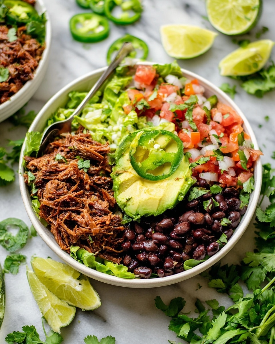A white bowl filled with five distinct layers starting with a green lettuce base at the bottom, followed by shredded brown meat on the left side next to a spoon, bright sliced green avocado in the center, black beans on the right side, and colorful pico de gallo made of red tomatoes and white onions on top around the avocado. Thin slices of green jalapeño peppers are spread around the edges. The bowl is set on a white marbled surface with lime wedges and fresh cilantro leaves scattered around. Photo taken with an iphone --ar 4:5 --v 7