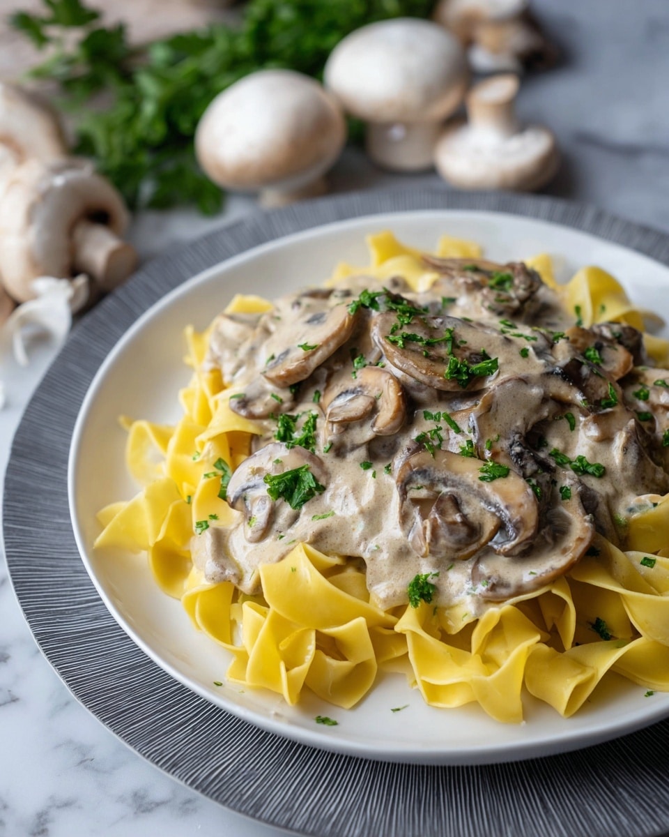 A black pan filled with a brown mushroom and beef stew, with visible slices of mushrooms and strips of beef throughout, topped with a thick layer of white cream swirled gently on the surface. A wooden spoon rests inside the pan, partially submerged in the stew on the right side. Around the pan, there is a white mug with light brown foam at the top on the upper left, a white bowl with a whisk and a small amount of sauce on the upper right, a small wooden bowl on the right side, and an empty black bowl with white sauce residue beside the pan. All items rest on a white marbled surface. photo taken with an iphone --ar 4:5 --v 7