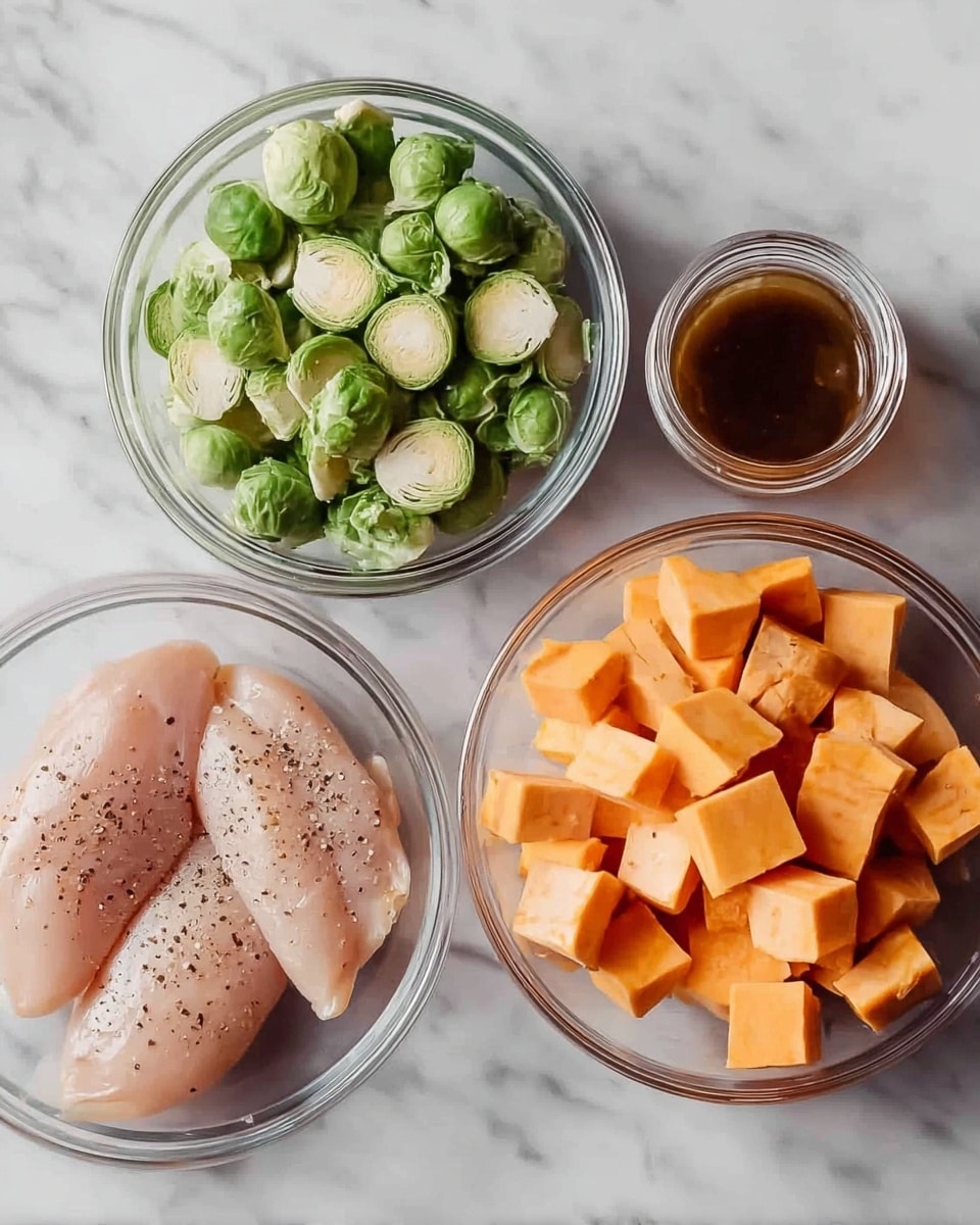 The image shows four glass bowls arranged on a white marbled surface. The first bowl contains three raw chicken fillets with sprinkled black pepper, showing a light pink color and smooth texture, positioned on the bottom left. The second bowl at the bottom right holds cubes of sweet potato, orange in color with sharp edges and a firm texture. The third bowl, located at the top right, is filled with halved Brussels sprouts, bright green in color with layered leaves visible. In the center at the top, there is a small jar filled with a dark brown liquid, likely sauce or marinade, with a smooth glass texture. photo taken with an iphone --ar 4:5 --v 7