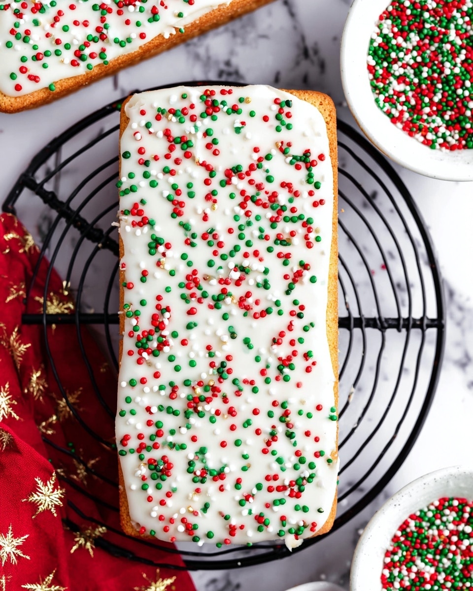A rectangular cookie with one thick layer of smooth white icing fully covering the top, sprinkled evenly with small round sprinkles in red, green, and white colors, sitting on a black wire cooling rack over a white marbled surface. Two white bowls filled with similar sprinkles are placed on the right side. There is a hint of red fabric with gold star patterns on the top left and bottom left corners of the image. Photo taken with an iphone --ar 4:5 --v 7