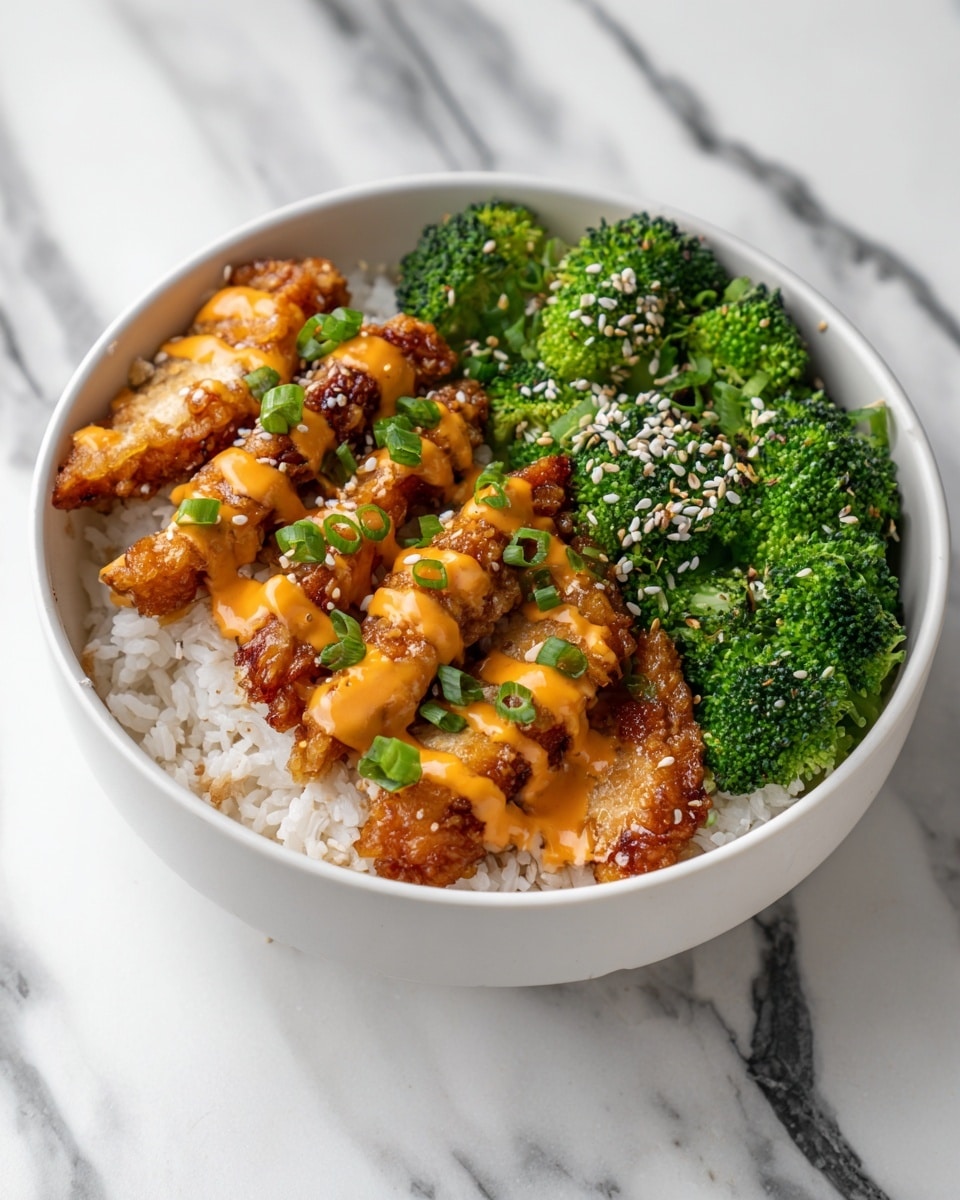 A white bowl filled with three main layers: at the bottom is a base of white rice, on the left side there are several golden brown fried chicken strips with a drizzle of bright orange sauce and sprinkled with white sesame seeds and small green onion pieces, and on the right side there are fresh green broccoli florets sprinkled lightly with white sesame seeds, all placed on a white marbled surface. photo taken with an iphone --ar 4:5 --v 7