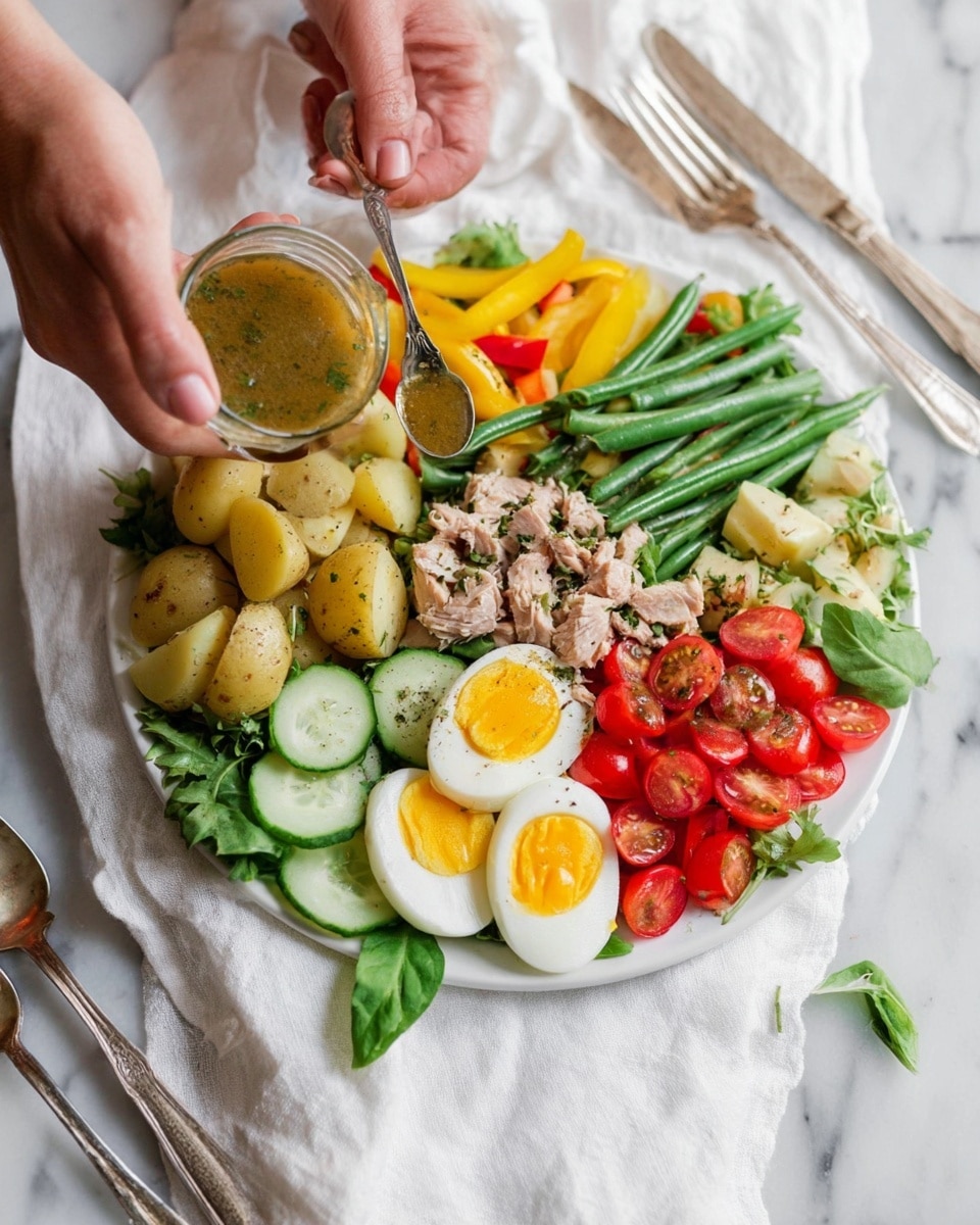 A white plate holds a colorful salad arranged in layers around the edge. Starting at the left side, there are thick pale yellow potato halves with skins on, next to bright green beans. Moving clockwise, there are roasted red and yellow pepper strips above the green beans. Next, there are small chunks of pale tuna, beside halved red cherry tomatoes on the far right. Below the tuna and tomatoes, quartered boiled eggs with bright orange yolks and firm white edges are placed. In the bottom center, thin round cucumber slices with dark green skins lie next to the eggs. Fresh green leafy herbs are tucked in the gaps. A woman's hand is pouring a light brown herb dressing from a small glass container onto the salad with the help of a spoon in her other woman's hand. The plate sits on a white cloth with silver forks nearby, all on a white marbled surface. photo taken with an iphone --ar 4:5 --v 7