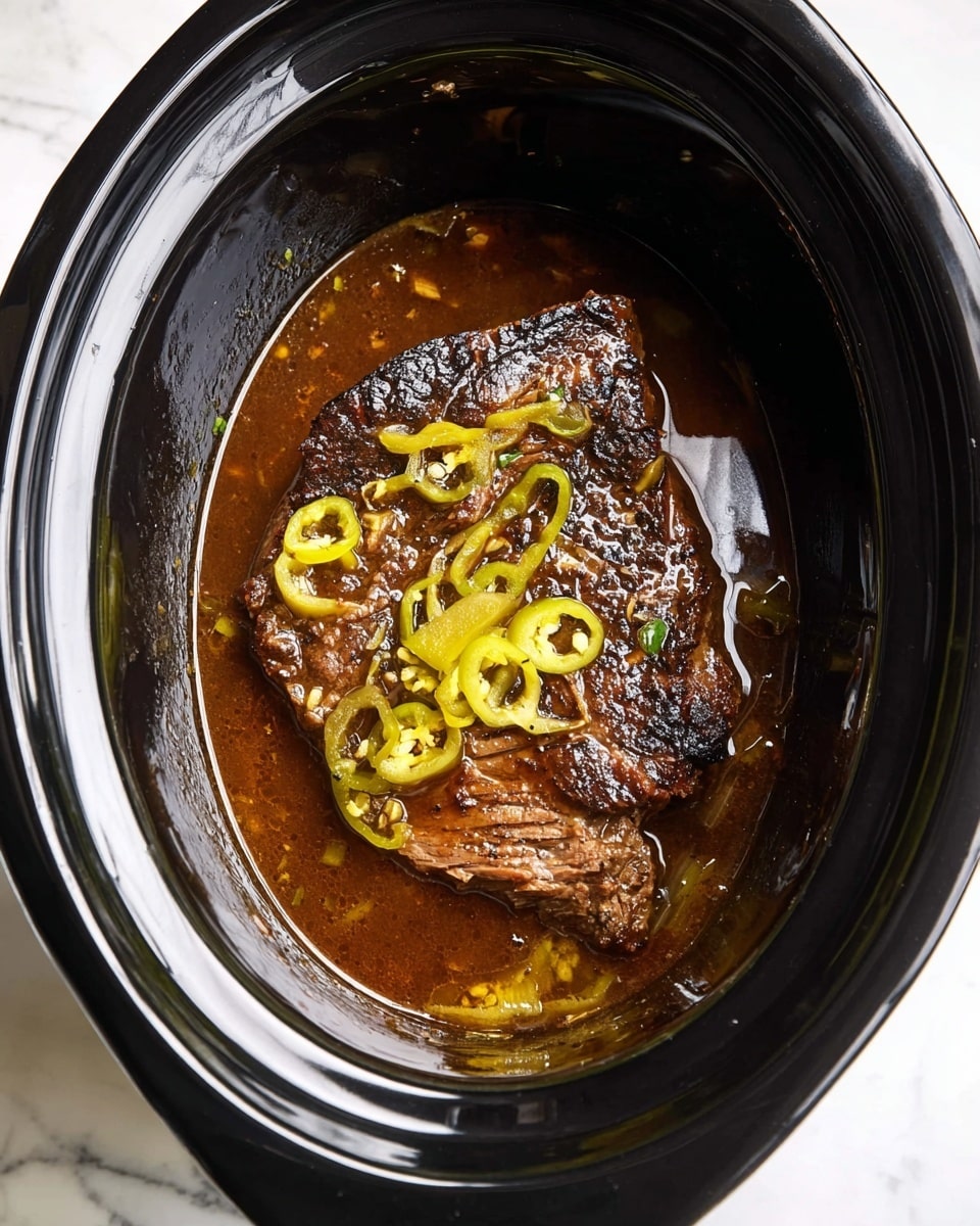 A piece of dark brown cooked meat with some charred black spots is placed inside a black slow cooker filled with a shiny brown broth. On top of the meat, there are sliced yellow-green peppers scattered unevenly. The inside of the cooker is glossy black, and the cooker sits on a white marbled surface. photo taken with an iphone --ar 4:5 --v 7