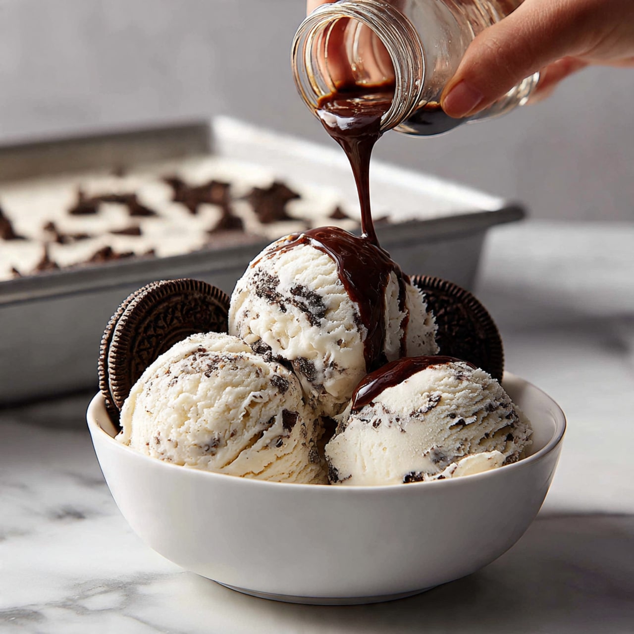 A white bowl holds three scoops of light pink ice cream with dark chocolate streaks inside. The ice cream is decorated with fresh red strawberry slices placed around the edges of the bowl. A silver spoon is resting inside the bowl on the right side. Dark chocolate sauce is being poured over the top scoop, creating a glossy drip down the ice cream. The bowl is set on a white marbled surface. photo taken with an iphone --ar 4:5 --v 7