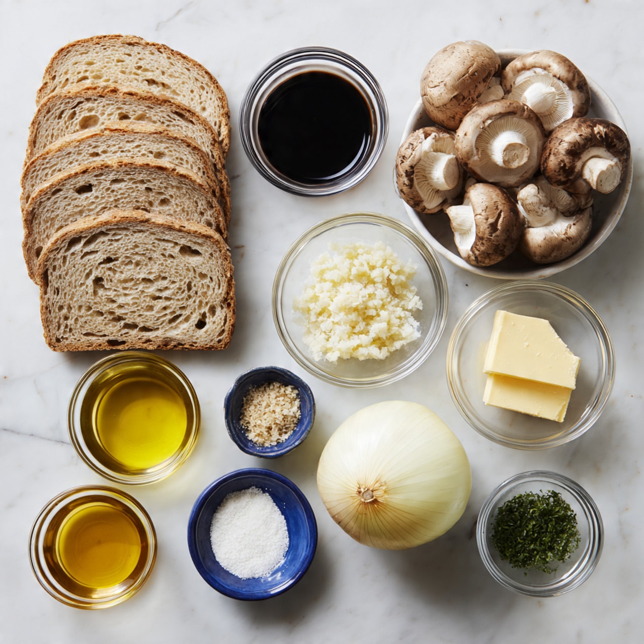 The image shows ingredients laid out on a white marbled surface, arranged neatly in separate small glass bowls and loose piles. On the left, there are seven slices of light brown bread stacked slightly overlapping. At the top center are dark soy sauce in a round glass bowl and four whole light brown mushrooms with dark gills facing up. Below them, from left to right, are minced garlic in a small glass bowl, white salt in another, white mayonnaise in a larger glass bowl, green herbs in a small bowl, and yellow butter in a small bowl. Below the bowls, there is a whole yellow onion resting near a blue packet of Swiss cheese slices that is partially open showing a few pale yellow slices visible. Two round glass bowls of light-colored oil and dark balsamic vinegar sit near the bottom left. The layout and colors make each ingredient easily identifiable. Photo taken with an iphone --ar 4:5 --v 7