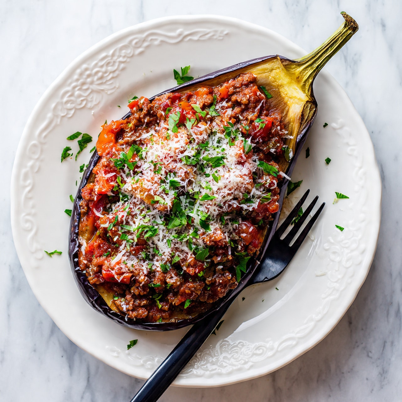 The image shows four eggplants halved lengthwise on a white rectangular tray with black edges, each topped with a chunky red tomato sauce and sprinkled with grated cheese and green herbs. The eggplants have dark, charred skin with golden brown flesh visible around the sauce. Next to the tray is a silver pot with handles, filled with more tomato sauce, and a ladle resting inside it. Both the tray and pot sit on a white marbled surface. The scene is bright and clean, with scattered small bits of green herb adding color. photo taken with an iphone --ar 4:5 --v 7