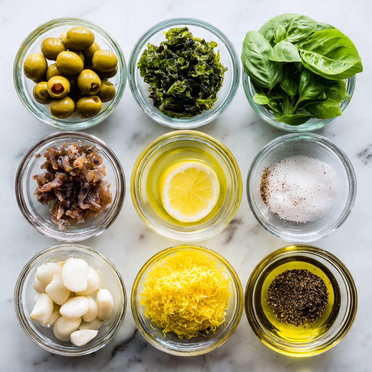 The image shows nine small clear glass bowls arranged in a 3 by 3 grid on a white marbled surface. The top row has large green olives in the left bowl, dark green capers in the middle, and fresh green basil leaves in the right bowl. The middle row contains brown anchovy pieces in the left bowl, light yellow lemon juice in the middle, and white salt in the right bowl. The bottom row displays white garlic cloves in the left bowl, bright yellow lemon zest in the middle, ground black pepper in the right middle bowl, and golden olive oil filling the right bowl. All bowls are transparent and the colors of the ingredients are clear and vibrant. photo taken with an iphone --ar 4:5 --v 7
