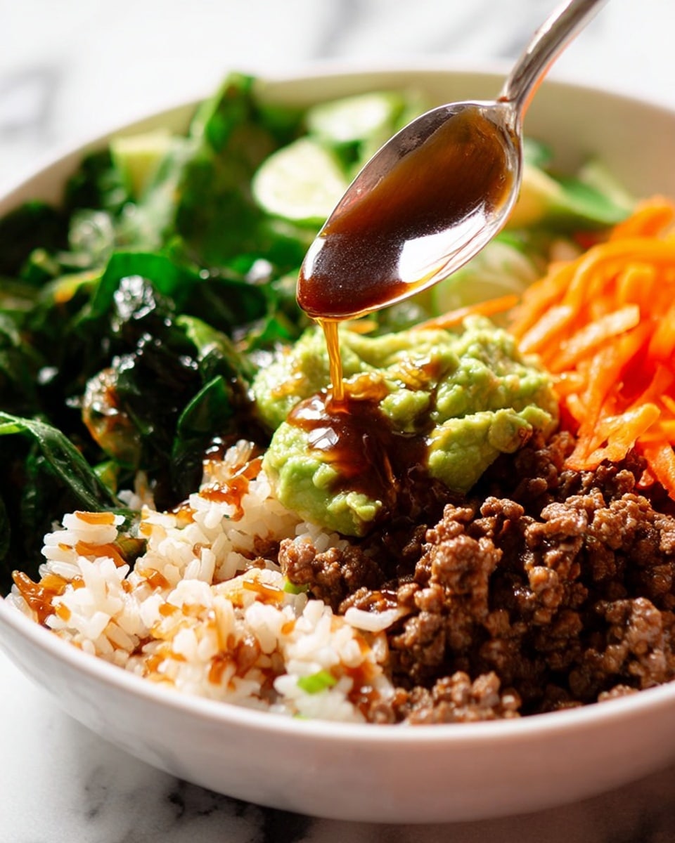 A close-up of a bowl showing three main layers: at the bottom, cooked dark green leafy vegetables; in the middle, white and brown mixed rice with small bits of cooked ground meat that is dark brown; on top, bright green mashed avocado and thin orange carrot strips. Above the bowl, a spoon held by a woman's hand drizzles a shiny, dark brown sauce over the ingredients. The bowl is white and the surface beneath it is white marbled. The photo taken with an iphone --ar 4:5 --v 7