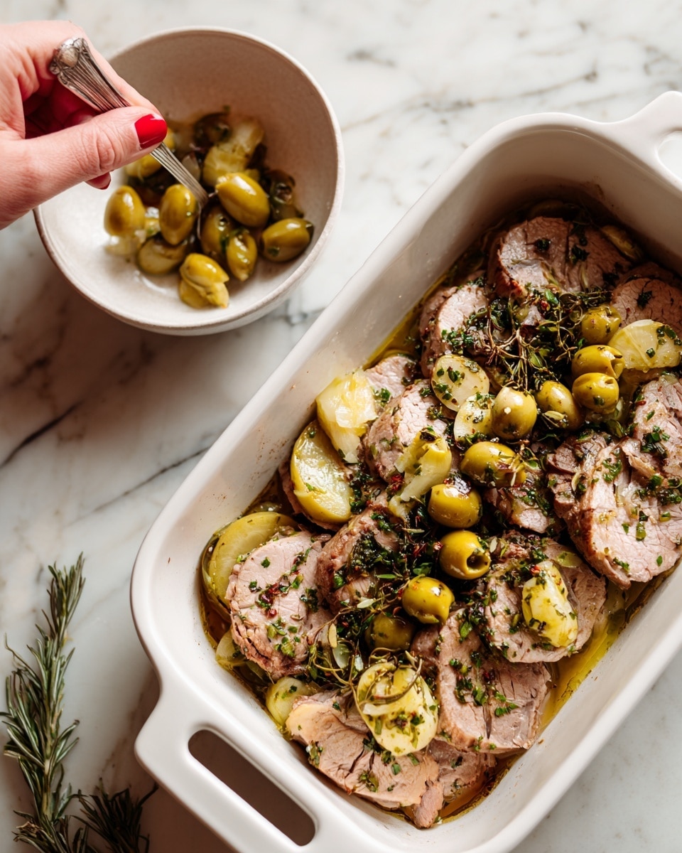 A white rectangular baking dish filled with multiple round slices of cooked light brown meat, layered closely together. Small green olives and chopped dark herbs are scattered on top of the meat slices. A woman's hand with red nail polish is holding a spoon, placing more olives and herbs onto the meat from a white bowl nearby. The baking dish and bowl are on a white marbled surface. photo taken with an iphone --ar 4:5 --v 7