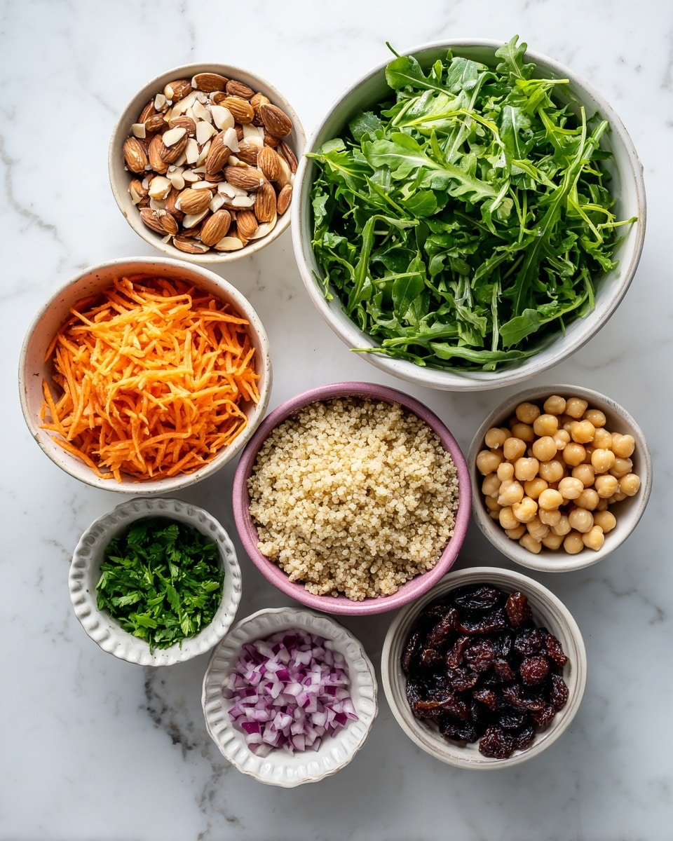 The image shows eight white bowls of different sizes arranged on a white marbled surface. The largest bowl on the right holds fresh, dark green arugula leaves with a slightly rough texture. Below it, a medium-sized white bowl contains light beige cooked quinoa with a grainy texture. To the left, another medium white bowl contains shredded bright orange carrots with thin, fine strips. Next to the quinoa bowl is a pink bowl filled with round, beige chickpeas. Above the chickpeas, a small white bowl holds chopped dark green mint leaves. Near the bottom, two small white bowls show finely chopped light purple onions and chopped dark reddish-brown dates. At the top left, a small fluted white bowl contains roughly chopped brown almonds with white insides visible. All bowls are on a clean white marbled background. Photo taken with an iphone --ar 4:5 --v 7