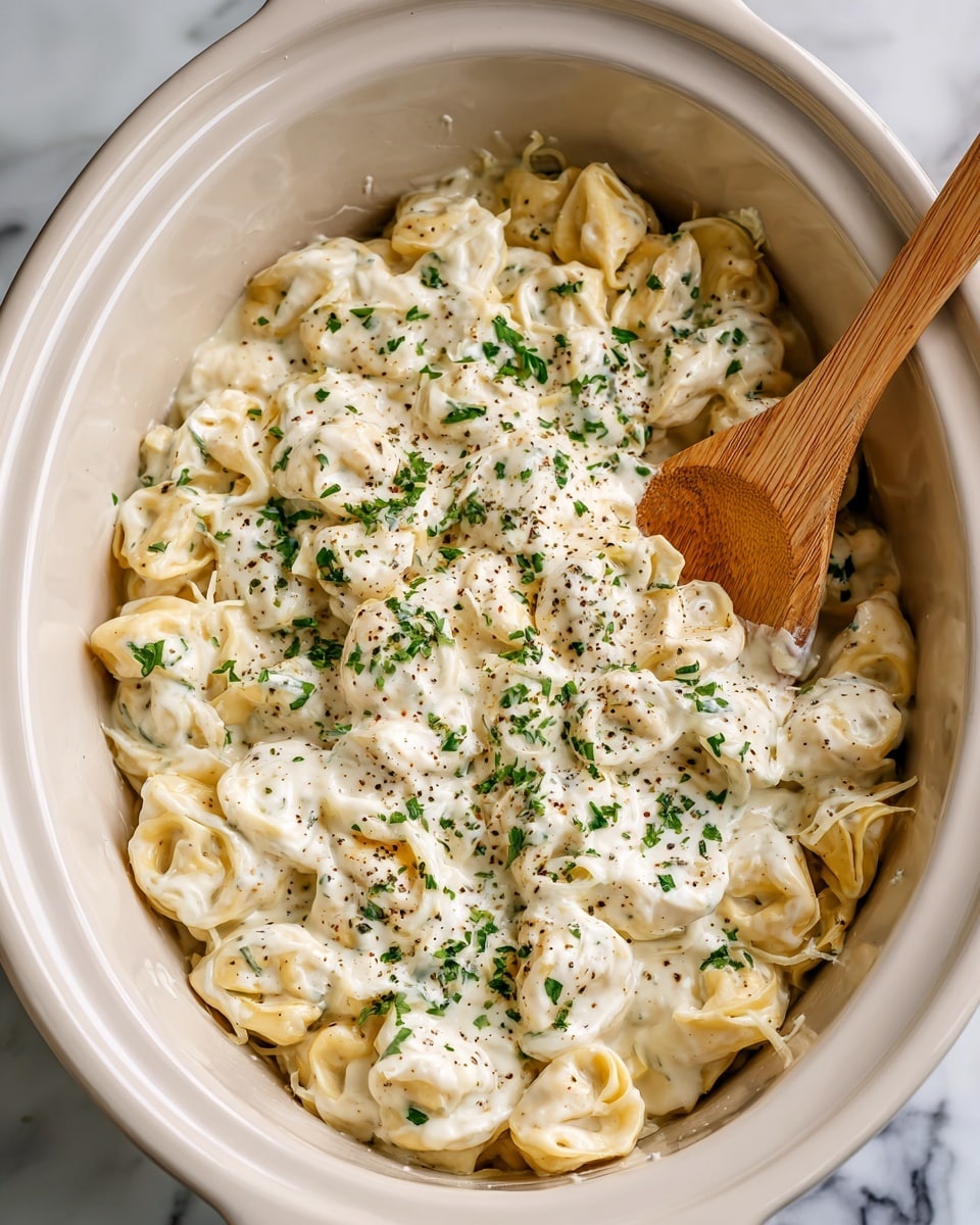 Two white bowls with black rims are filled with creamy pasta layered with pale yellow tortellini mixed with shredded light-colored chicken, sprinkled with small green parsley pieces and black pepper. Each bowl has a black spoon resting inside, partly covered by the pasta. To the left, there is a white rectangular plate holding five toasted bread slices topped with melted golden brown cheese. In the top right corner, a large white bowl contains a fresh green leafy salad. A striped white and gray cloth is placed near the bottom right corner, all set on a white marbled surface. Photo taken with an iphone --ar 4:5 --v 7