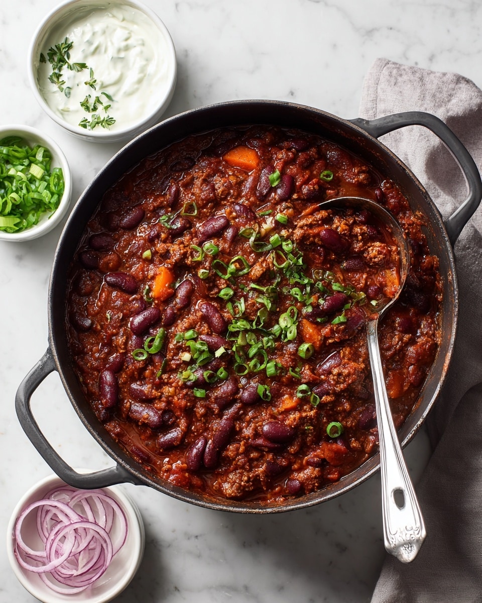 A cast iron pot filled with thick chili, showing two main layers: a rich dark red meat sauce mixed with kidney beans and visible chunks of orange carrot, topped with scattered sliced green onions for a fresh pop of color; a metal ladle rests inside the pot on the right side. Around the pot on a white marbled surface, there are three small white dishes: one with bright green chopped scallions, one with white creamy sauce garnished with a few green herbs, and one with thin rings of pale pink onions. A light gray cloth is partially visible on the right edge of the scene. Photo taken with an iphone --ar 4:5 --v 7