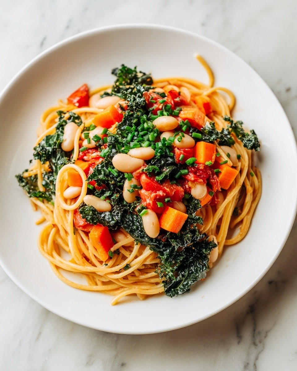 A white plate filled with three main layers: the bottom layer is light brown linguine pasta, tangled and spread across the plate; on top of it, there are bright orange carrot cubes and dark green leafy kale pieces evenly distributed; the top layer has white beans, small pieces of red tomato, and scattered green chopped herbs like chives, adding color and texture contrast. The plate is set on a white marbled surface. photo taken with an iphone --ar 4:5 --v 7