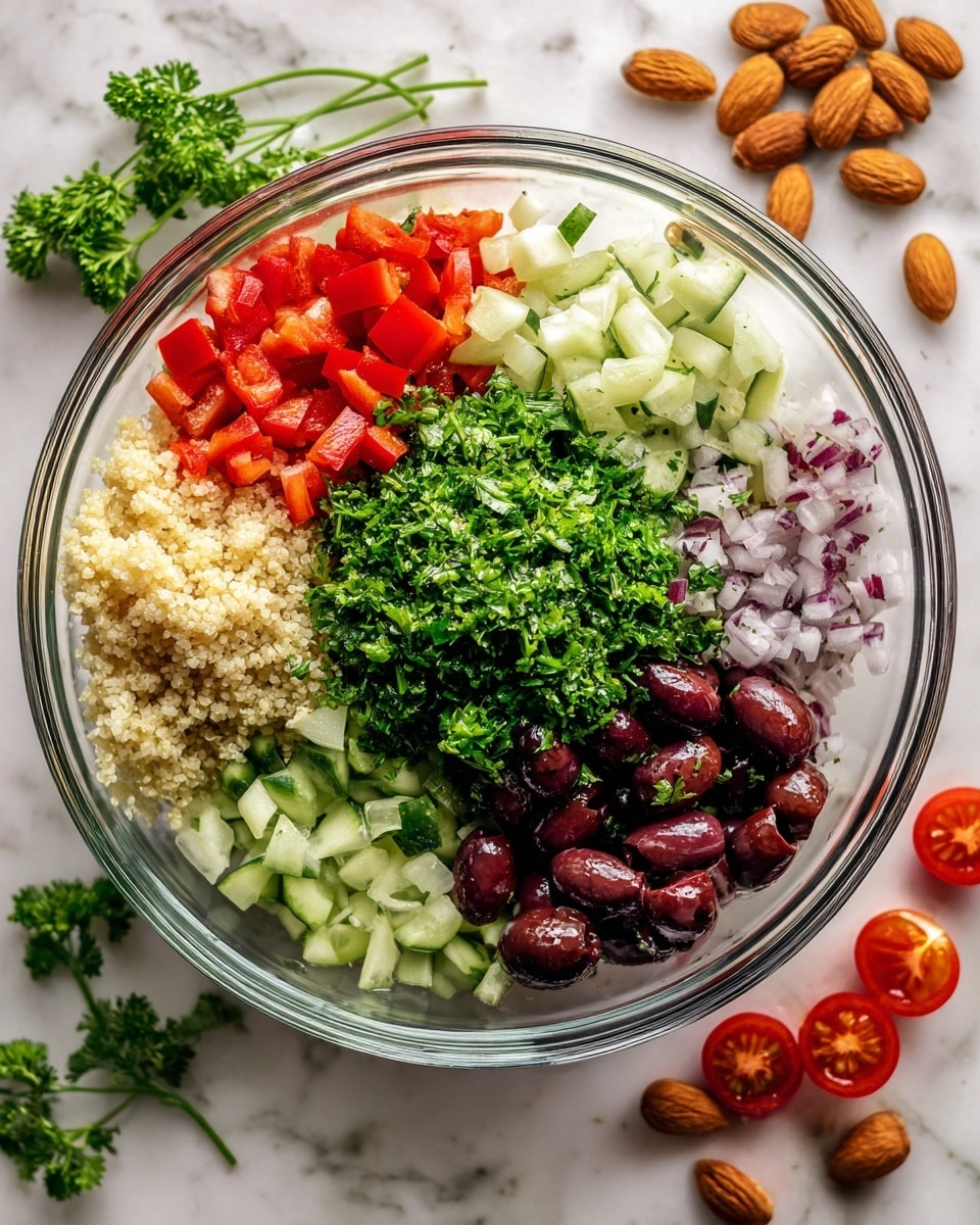 A clear glass bowl sits on a white marbled surface, filled with layers of finely chopped fresh ingredients. Starting from the bottom, there is a layer of light beige grains, likely quinoa or couscous. Above this, neatly arranged in sections, are bright red diced bell peppers and light green cucumber cubes. Next to these is a heap of chopped white onions, and near them, a pile of small, glossy dark purple olives scattered among the other ingredients. A generous mound of finely chopped fresh green parsley is placed in the center, covering some of the olives. Around the bowl on the surface are scattered halved cherry tomatoes, almonds, and sprigs of parsley. The overall look is colorful and fresh, showcasing a mix of red, purple, green, and white tones. Photo taken with an iphone --ar 4:5 --v 7