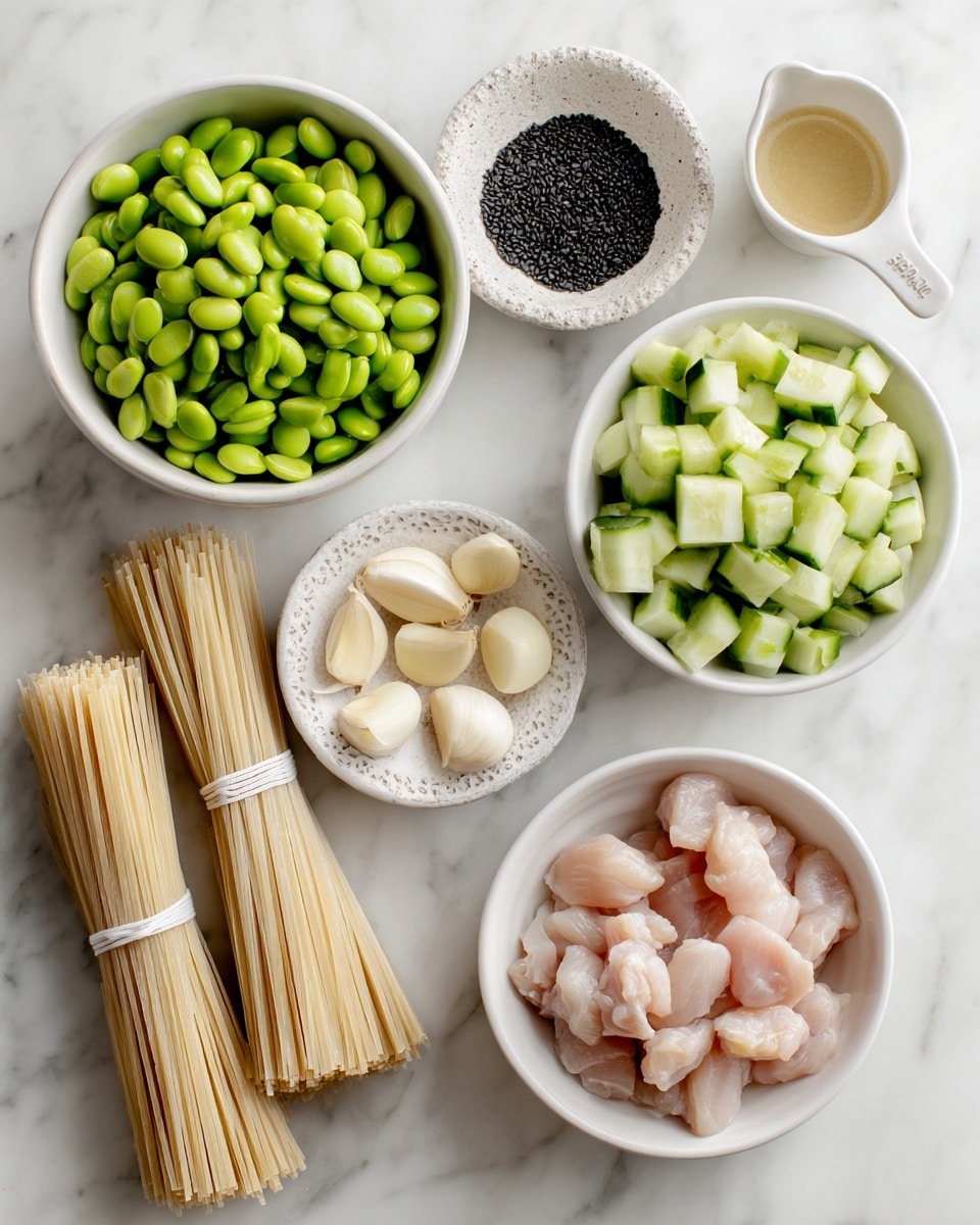 The image shows several ingredients neatly arranged on a white marbled surface. There is a white bowl filled with bright green edamame beans at the top left, and below it are three bundles of thin dry noodles tied with white bands, placed side by side. Near the center is a small white dish with a textured edge filled with black sesame seeds. To the right, a white measuring cup contains a light beige sauce or paste. Next to it are several peeled garlic cloves and a whole garlic bulb. At the bottom right, a white bowl holds raw pale pink chicken pieces, and in the bottom center, another white bowl is filled with chopped cucumber pieces, showcasing their fresh green skin and light green interior. The clean, bright setting emphasizes the fresh and raw nature of the ingredients. photo taken with an iphone --ar 4:5 --v 7