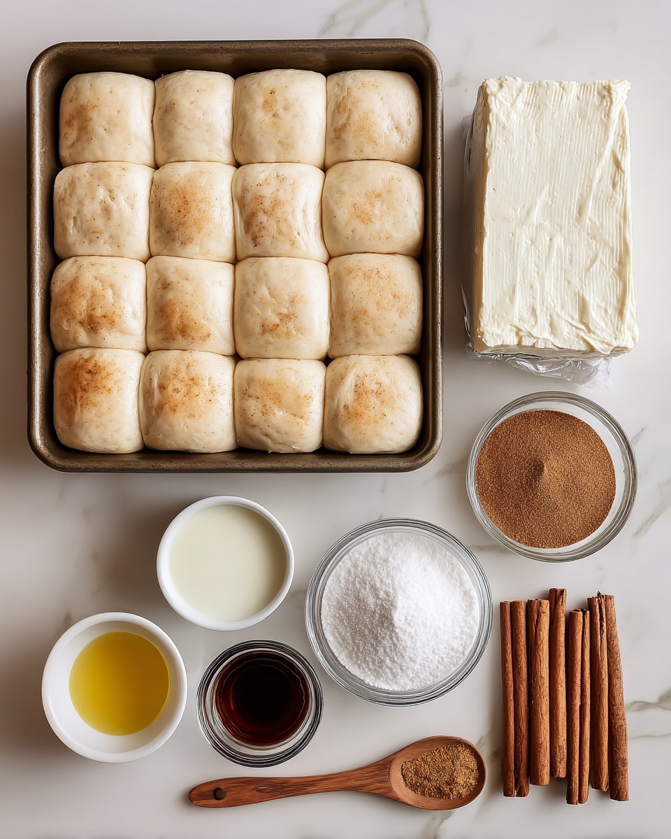 The image shows a baking pan filled with frozen dough rolls, light beige in color, lined up closely together in rows and columns at the top left. To the right of the pan is a block of cream cheese wrapped in foil, white with a slightly crumbly texture. Below are small white bowls and a glass cup holding different ingredients: a white bowl of canola oil, a smaller white bowl with milk, a clear glass bowl with vanilla extract (dark amber), another white bowl filled with white granulated sugar, and a white bowl with powdered sugar. There is also a small wooden spoon with ground cinnamon, brown powder, sitting next to three cinnamon sticks, darker brown and textured, all placed on a white marbled surface. photo taken with an iphone --ar 4:5 --v 7