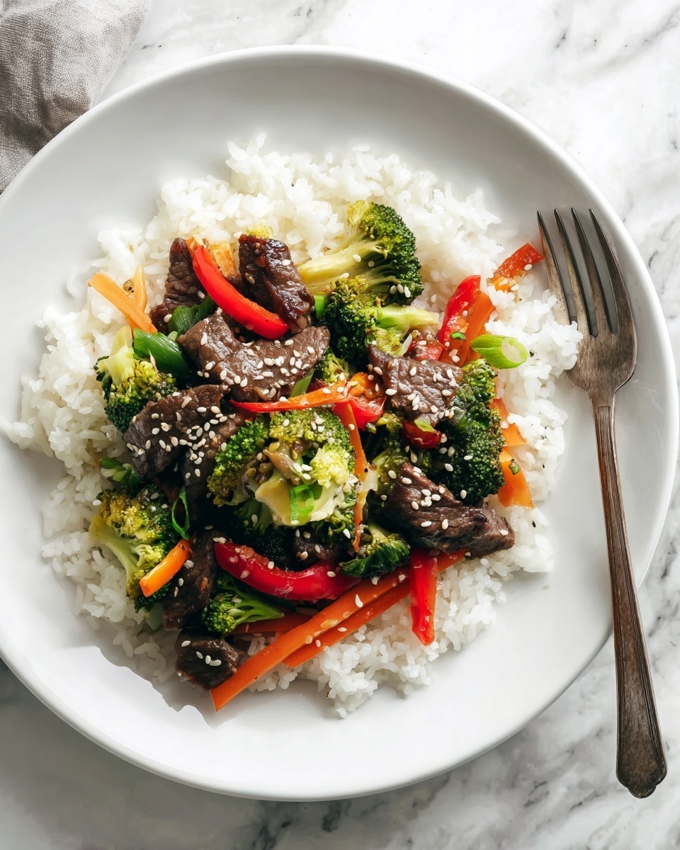A white plate holds a bed of fluffy white rice forming the first layer, soft and slightly spread out. On top, the second layer is made of pieces of dark brown cooked beef mixed with small bright green broccoli florets and thin red bell pepper strips, along with some orange carrot slices, all cooked but still fresh in color. Light tan sesame seeds are sprinkled over the whole dish, adding small textured dots. The plate sits on a white marbled surface, and to the right, a fork with a silver head and wooden handle rests partially visible. Photo taken with an iphone --ar 4:5 --v 7