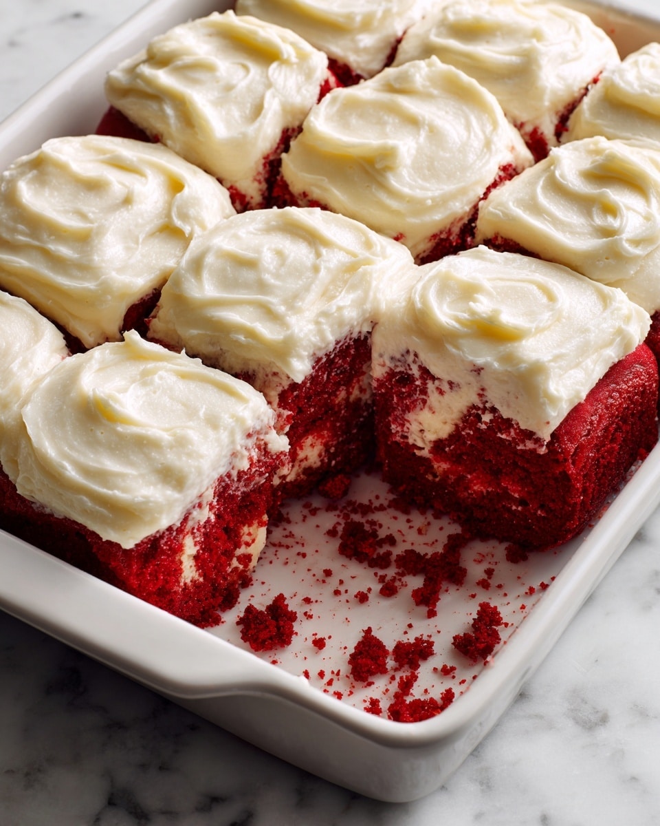A single piece of bright red cake with a soft, spongy texture sits in the center of a white plate. It has one layer of deep red cake topped with a thick, creamy layer of white frosting that slightly drips down the sides. In the background, there is a red baking dish and a blue and white checkered cloth on a white marbled surface. photo taken with an iphone --ar 4:5 --v 7