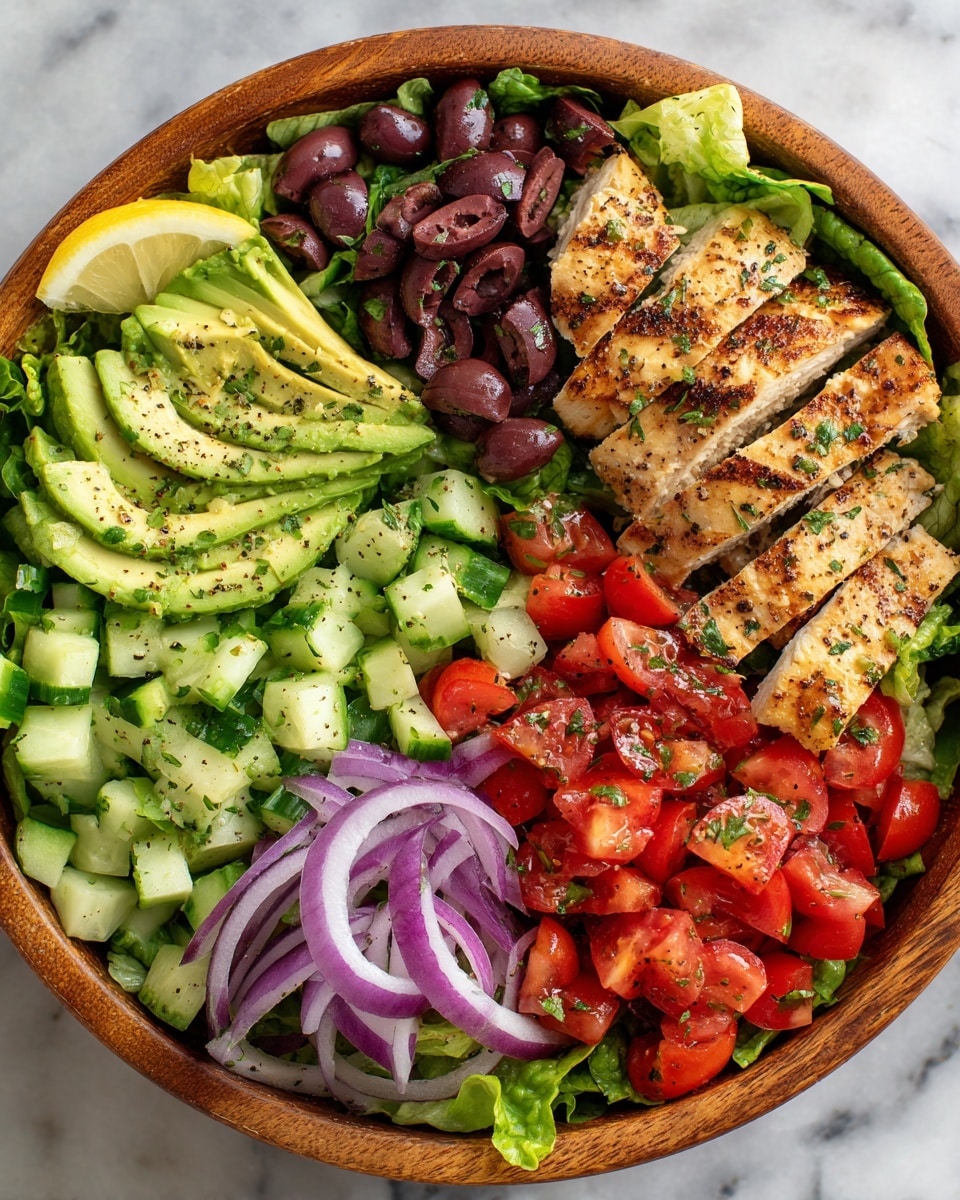 A round wooden bowl filled with fresh salad arranged in layers on a white marbled surface. The bottom layer is green lettuce leaves, slightly crinkled. On top of the lettuce are diced bright red tomatoes, chopped green cucumbers, and slices of dark purple olives scattered evenly. There are also thin slices of red onion mixed throughout the salad. On one side of the bowl, a neat layer of golden brown grilled chicken strips with visible grill marks rests over the greens. Next to the chicken, thick slices of creamy light green avocado are fanned out, seasoned with black pepper and small green herb sprinkles. A wedge of lemon is placed at the top edge of the bowl. photo taken with an iphone --ar 4:5 --v 7