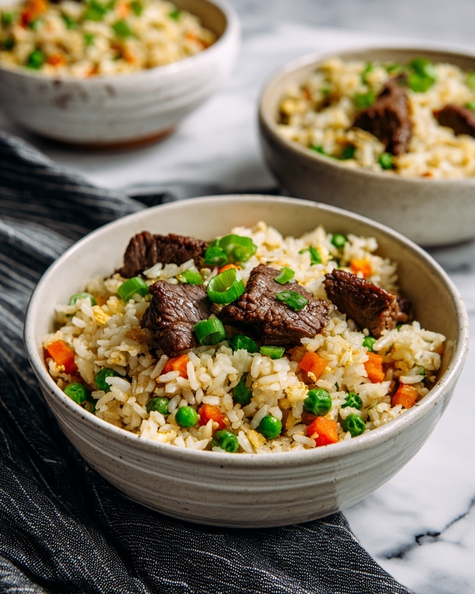 A large pan filled with fried rice shows several layers: the base is white and brown rice mixed evenly with small green peas and orange carrot cubes. Scattered throughout are chunks of cooked dark brown beef and small pieces of yellow scrambled eggs. A metal spoon rests inside the pan, mixing the rice. Nearby, two small white bowls sit on a white marbled surface, one with bright green sliced spring onions and the other with tan sesame seeds. A gray striped cloth lies beneath one handle of the pan. Photo taken with an iphone --ar 4:5 --v 7