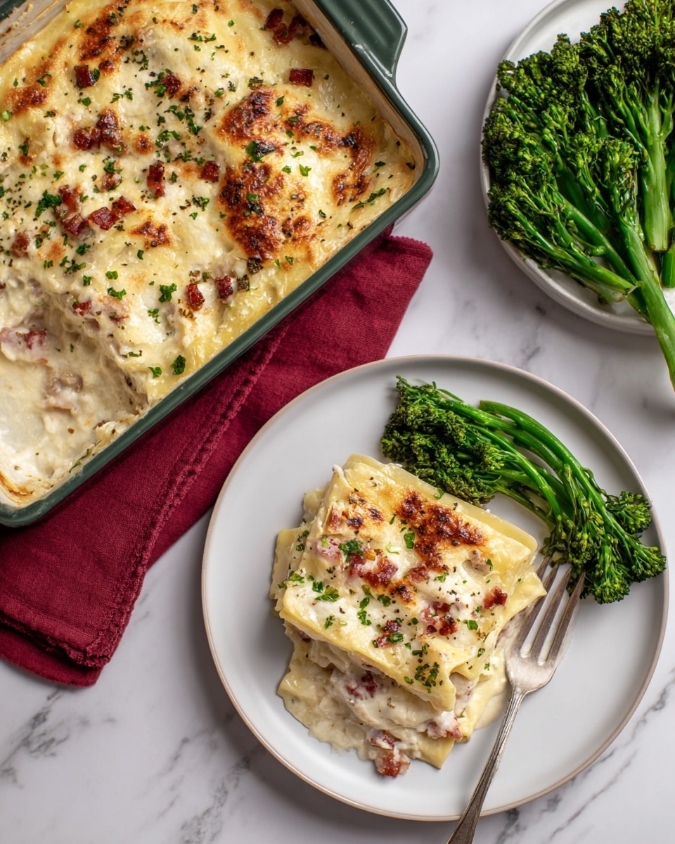 The image shows two black plates on a white marbled surface, each with a square piece of baked fish topped with chopped green herbs. The fish is white with a golden-browned top layer. Next to the fish on each plate are bright green broccolini stalks. One plate also has two slices of crusty bread positioned behind the fish. A fork and knife rest on the edge of the main plate, with the knife crossed over the fork. A brown cloth napkin lies beneath the utensils. Nearby, a small wooden bowl holds chopped green herbs, and there is some grated cheese scattered on a piece of parchment. A clear glass of water is placed near the main plate. Photo taken with an iphone --ar 4:5 --v 7