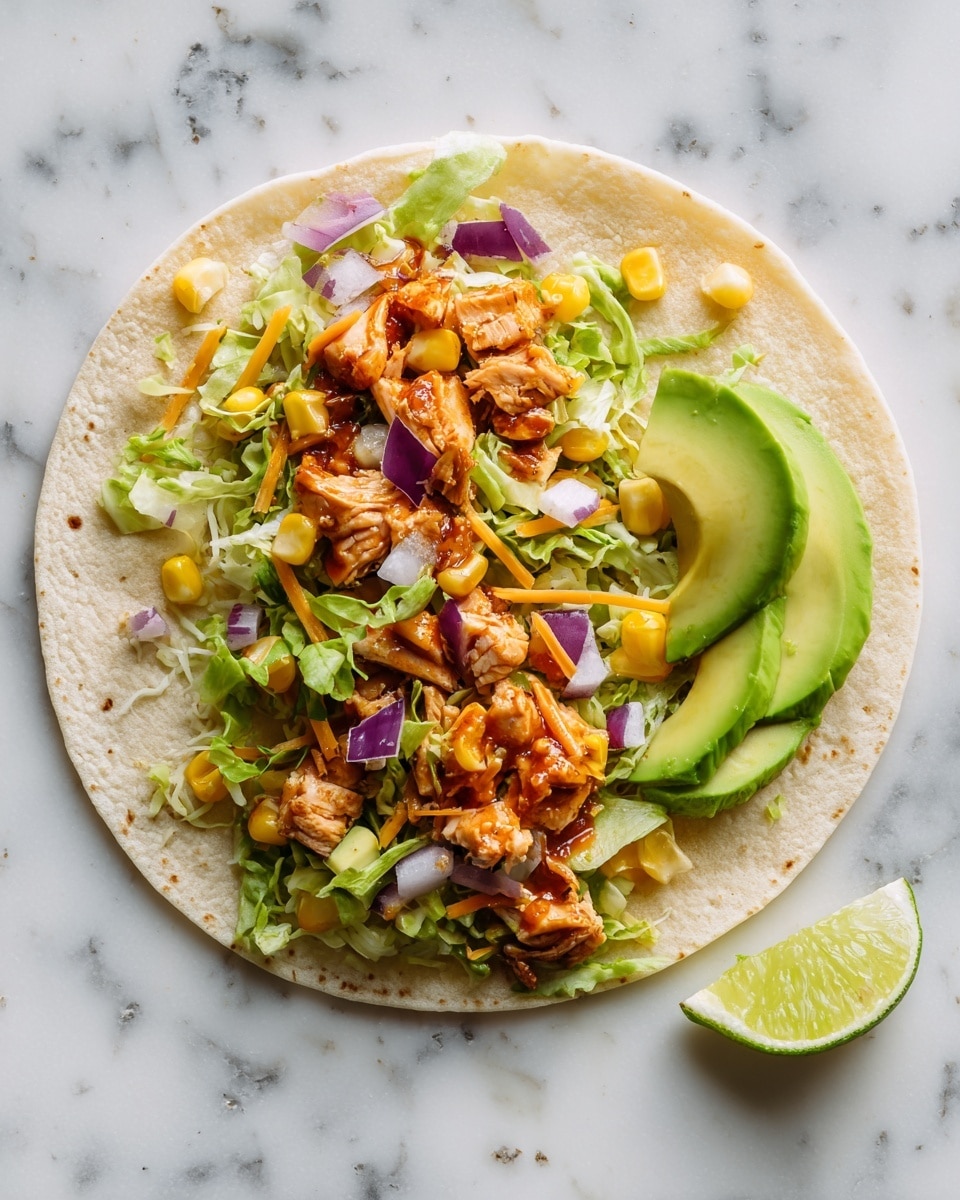 A single flat tortilla lies flat on a white marbled surface, topped with multiple layers of colorful ingredients. The base layer is shredded green lettuce spread unevenly, followed by chunks of cooked shredded chicken with a reddish sauce, scattered throughout. Bright yellow corn pieces are placed in small groups, adding pops of color. Thin strips of orange cheese are lightly sprinkled across. There are also thin purple pickled onion slices distributed on top. Two slices of fresh green avocado sit on the right side of the tortilla. A lime wedge rests near the bottom right edge on the white marbled surface. The overall look is fresh, vibrant, and slightly messy but appealing. photo taken with an iphone --ar 4:5 --v 7