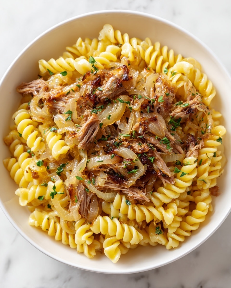 The image shows a close-up of a dish with three main layers. The bottom layer is yellow spiral pasta with a smooth texture. On top of the pasta, there are caramelized onions that are soft and golden-brown in color. Scattered throughout the dish are pieces of shredded brown meat with a slightly crispy texture at the edges. The food is in a white bowl, and the background is a white marbled surface. Photo taken with an iphone --ar 4:5 --v 7