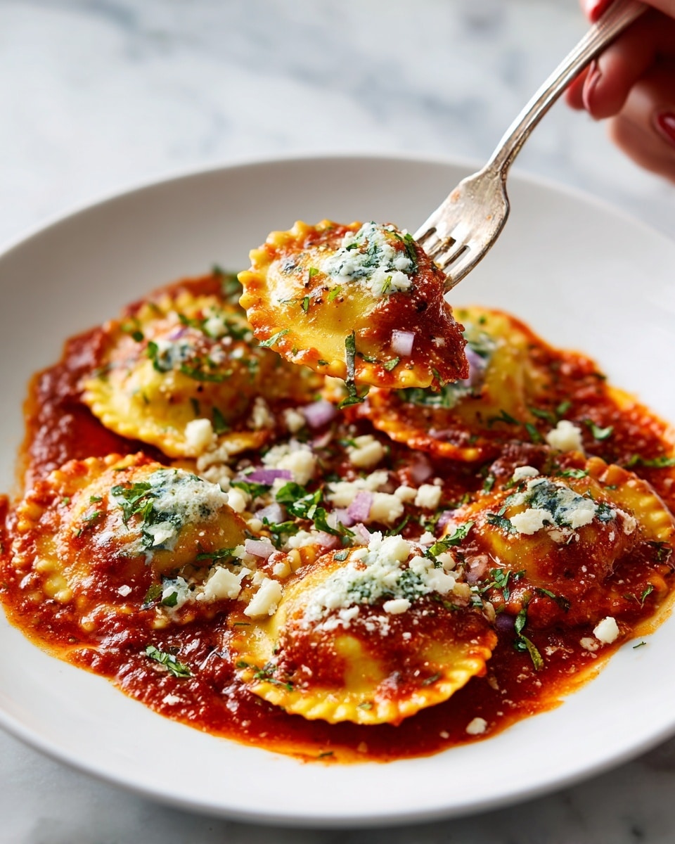 A white plate on a white marbled surface holds a dish of six half-moon shaped raviolis covered in thick red sauce. Each ravioli is light yellow with slightly crispy edges, topped with white crumbly cheese, small light purple onion pieces, and green chopped herbs. One ravioli is lifted by a fork held by a woman's hand, showing a creamy white topping on the ravioli and sauce dripping slightly onto the plate. The sauce is spread unevenly on the plate, creating a textured background for the ravioli. Photo taken with an iphone --ar 4:5 --v 7