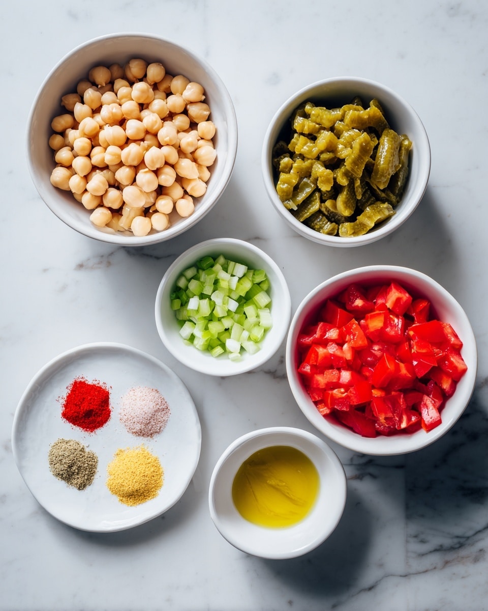 The image shows seven white bowls placed on a white marbled surface. The largest bowl on the top left is filled with light beige round garbanzo beans. To its right, a smaller bowl holds green pickle pieces. Below the pickle, there is a white bowl with bright red diced tomato, and on the bottom right, another similar-sized bowl contains more diced red tomato. On the bottom left, a shallow white plate displays a mix of powdered spices arranged in small piles: white onion powder, red paprika, light yellow garlic powder, and light pink salt. Above this plate, a small white bowl filled with bright yellow mustard is placed. To the left of the mustard, another small white bowl holds chopped green celery pieces. The composition is clean, colorful, and neatly organized. photo taken with an iphone --ar 4:5 --v 7