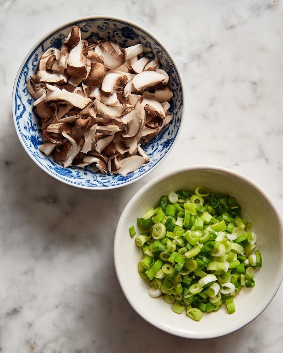 A close-up top view shows two bowls on a white marbled surface; the left bowl is white with a blue pattern and is filled with thick, unevenly sliced brown and white mushrooms layered loosely, while the right bowl is plain white and contains a pile of small, bright green chopped scallions spread evenly, with some scallion pieces scattered around the bowl and on the marbled surface next to the bowls. photo taken with an iphone --ar 4:5 --v 7