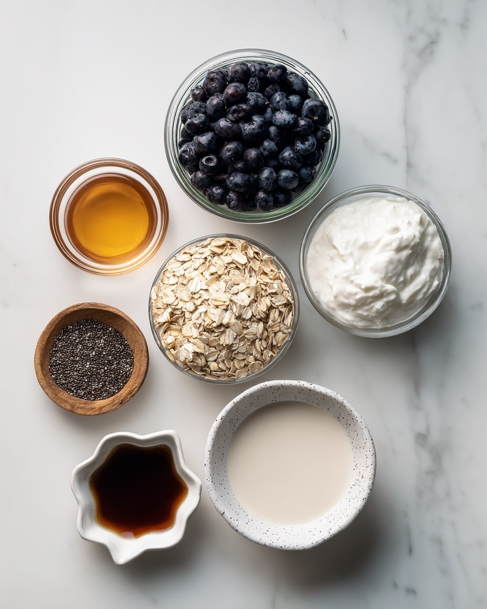 The image shows six small containers arranged on a white marbled surface. At the top center, a clear jar is filled with dark blue blueberries with a label on it. To the right, a clear jar holds white thick Greek yogurt. Below the yogurt, a clear bowl contains light brown old fashioned rolled oats. At the bottom center, a white speckled bowl is filled with light beige almond milk. To the left of the almond milk, a small white bowl contains amber maple syrup. Above that, a small brown wooden bowl is filled with small black chia seeds. At the bottom left, a small scalloped dish holds dark brown vanilla liquid. Each ingredient is labeled with white text boxes. Photo taken with an iphone --ar 4:5 --v 7
