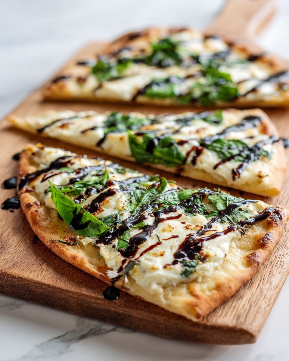 The image shows three slices of flatbread pizza on a wooden board placed on a white marbled surface. The flatbread has a light golden crust, topped with fresh green spinach leaves as the first visible layer, followed by melted white cheese covering most of the spinach. Thin, dark brown lines of balsamic glaze are drizzled across the top in diagonal stripes, adding contrast. The texture of the cheese is smooth and slightly stringy, while the spinach leaves add a fresh leafy look under the cheese. Photo taken with an iphone --ar 4:5 --v 7