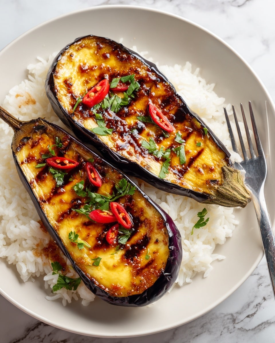 Four large eggplant halves lie flat on a baking tray with ridges. Each eggplant is cut lengthwise, showing soft orange-yellow flesh with dark grill marks in a crosshatch pattern. The surface of the eggplants is covered in a thick, shiny reddish-brown sauce that has small bits of garlic or spices in it. The tray looks slightly used with some sauce spots outside the eggplants and faint baking marks. The background beneath the tray is a white marbled texture. photo taken with an iphone --ar 4:5 --v 7
