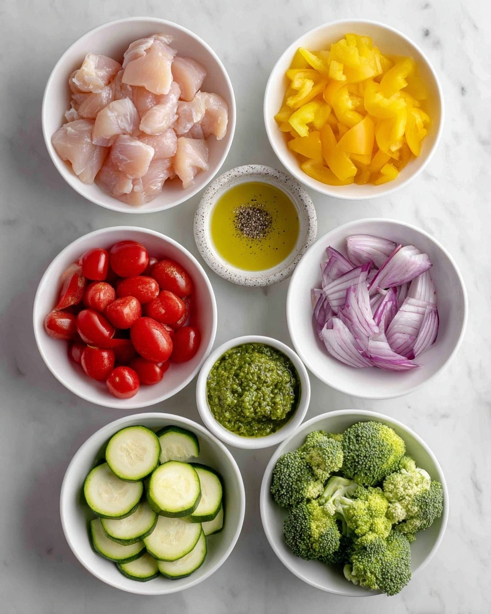 Top view of eight white bowls and a small white cup placed on a white marbled surface. The top left bowl contains light pink raw chicken pieces. To its right, the small white cup holds golden yellow oil. Below the oil is a round white bowl with blurred salt and pepper in a gray stone dish. Center bowl below chicken is filled with bright yellow chopped bell pepper. Bottom left bowl is filled with smooth, shiny red cherry tomatoes. Middle bowl below pepper contains a thick green pesto sauce with a somewhat grainy texture. To the right, a bowl shows bright green broccoli florets. Bottom left holds sliced zucchini showing white and green skin alternating along curved slices. Bottom right bowl contains roughly chopped purple-red onion pieces. All bowls are neatly arranged with labels over each showing the ingredient name. photo taken with an iphone --ar 4:5 --v 7