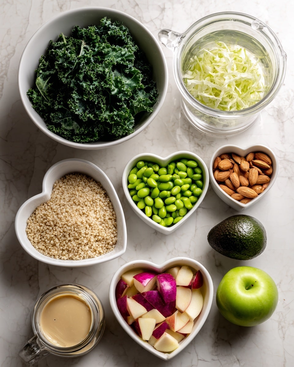 A top-down view of several white bowls and a glass container on a white marbled surface, each filled with different fresh ingredients: one large white bowl holds curly, dark green kale leaves, another white bowl contains light green shredded cabbage, and a third white bowl is full of bright green edamame beans. A heart-shaped white bowl is filled with light beige quinoa grains, while a matching heart-shaped bowl contains roughly chopped brown almonds. Next to these is a small white bowl filled with diced red and yellow apples. Two whole dark green avocados are placed beside the quinoa. A clear glass pitcher holds transparent water, and a small glass jar contains a creamy beige sesame ginger dressing. photo taken with an iphone --ar 4:5 --v 7