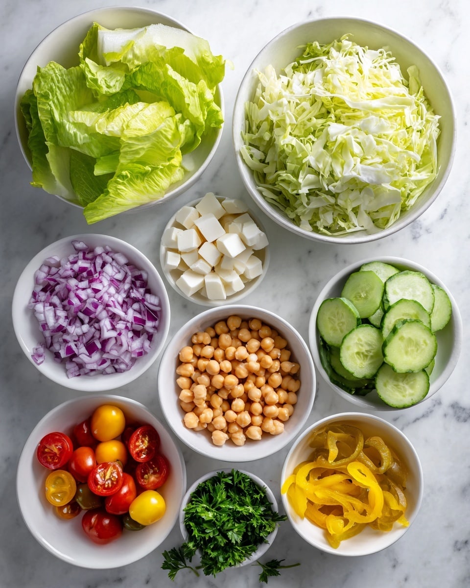 Several white bowls and a white plate are arranged on a white marbled surface, each filled with different fresh ingredients. A large white bowl in the top right is full of chopped light green cabbage with a crunchy texture. Below it, a small white bowl has shiny light brown chickpeas. Next to the chickpeas is a small bowl of finely chopped purple and white red onion. Below these, a bowl holds small white cubes of mozzarella cheese. A bunch of dark green parsley with leafy texture is placed in a small bowl at the bottom right. At the bottom left, a large white plate contains fresh green romaine lettuce leaves with crisp edges. Above the romaine, a white bowl shows light to dark green slices of cucumber with a smooth texture. To the left of the cucumbers, a small bowl holds red and yellow cherry tomatoes with smooth shiny skin. Above the cucumbers is a small bowl of bright yellow pepperoncini peppers, sliced and slightly wet. The whole setup is brightly lit with clear natural light. Photo taken with an iphone --ar 4:5 --v 7