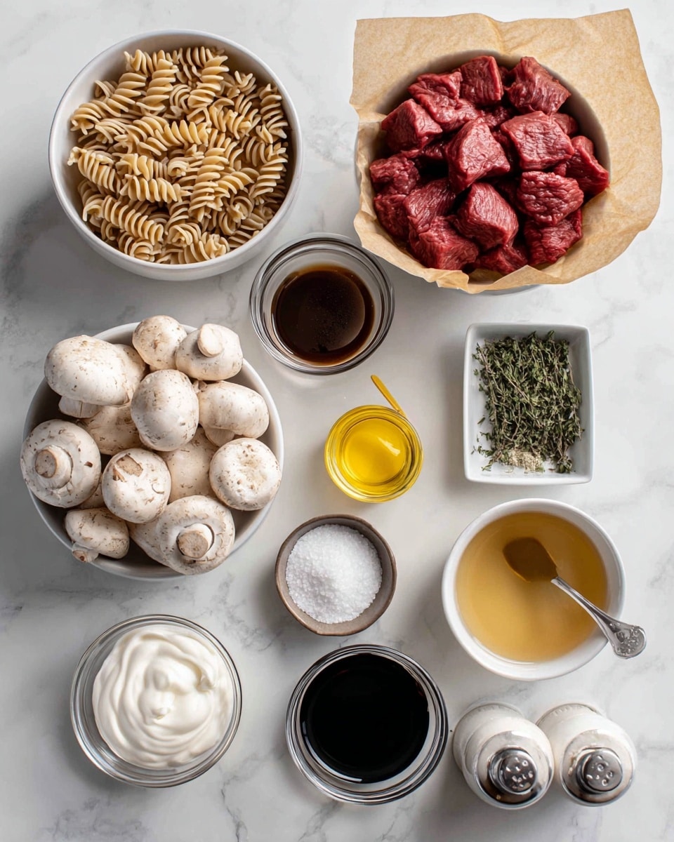 A white bowl filled with light brown spiral noodles sits at the top left. Below it, a small round white bowl holds plain white sour cream. Near the bottom left, a white bowl is piled with whole white mushrooms with brown spots. To the right of the mushrooms, a small shallow bowl contains dark brown Worcestershire sauce, with cornstarch in a small clear bowl next to it. A small glass jar of yellow mustard is near the bottom center. Above that is a medium white bowl lined with brown parchment paper, heaped with raw deep red beef chunks. To the right of the bowl are two small glass containers, one filled with dark red wine and the other with light yellow cooking oil. Next to the wine is a small square silver dish filled with green thyme and a small spoon. Below these, a clear glass bowl contains light brown broth. A white bowl of white flour mixes sits near the thyme. Salt and pepper shakers sit beside an unpeeled yellow onion at the bottom right. The whole scene is set on a smooth white marbled surface. Photo taken with an iphone --ar 4:5 --v 7