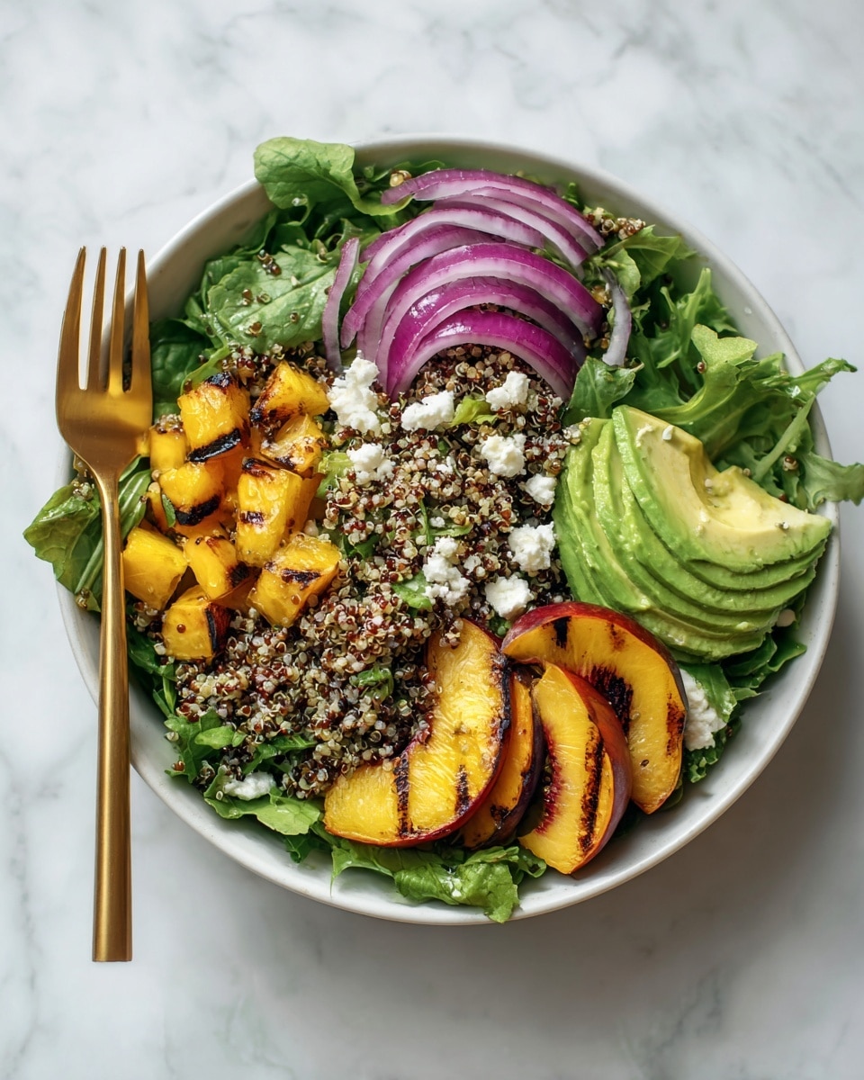 A white bowl sits on a white marbled surface filled with layers of fresh salad: the bottom layer shows dark green mixed leafy greens, followed by a layer of light beige quinoa grains. On top are scattered pieces of grilled yellow peaches with brown char marks, bright green sliced avocado, small chunks of purple-red onion, and white crumbled cheese. A fork and spoon rest inside the bowl against the food. Photo taken with an iphone --ar 4:5 --v 7