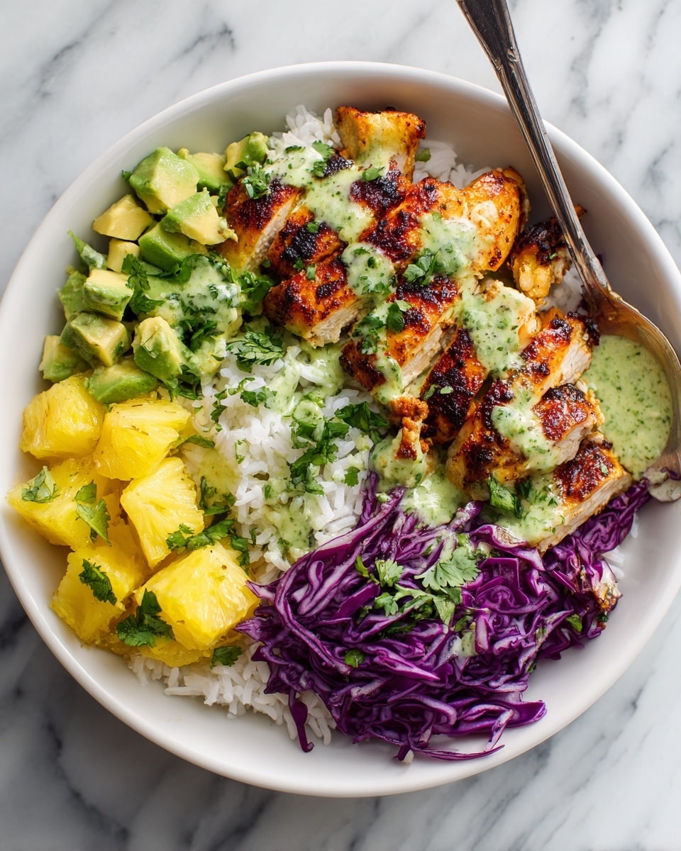 A white bowl filled with layers starting from the bottom white fluffy rice, topped with small yellow pineapple pieces on one side, bright green avocado chunks mixed with fresh green cilantro, and vibrant purple cabbage leaves stacked neatly at the back. On the right, there are crispy, browned sliced chicken layers with a crunchy, seasoned outer texture and juicy light inside. A silver spoon covered in thick green sauce with visible herb bits rests partly inside the bowl on the left side among the cilantro. The dish is presented on a white marbled surface photo taken with an iphone --ar 4:5 --v 7