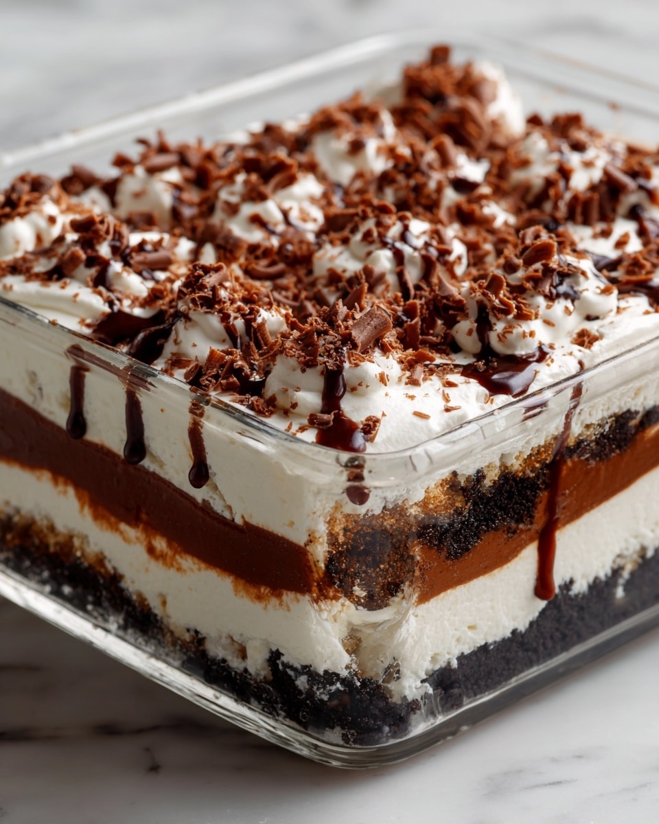 This image shows a clear rectangular glass dish with a layered dessert inside. The dessert has four visible layers: the bottom layer is dark and crumbly like crushed cookies, the second layer is creamy white, the third layer is thick and rich dark brown pudding, and the top layer is a smooth white cream. The top cream layer is decorated with many small brown chocolate curls spread evenly, along with thin drizzles of dark chocolate sauce. The dish is on a white marbled surface. photo taken with an iphone --ar 4:5 --v 7