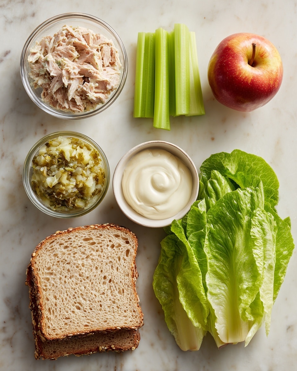 The image shows ingredients for a sandwich laid out on a white marbled surface. There are two slices of seeded bread at the bottom left, with a small glass bowl above holding a chunky greenish sweet relish. Next to the bread is a glass bowl filled with light pink canned albacore tuna. To the right, there's a white bowl containing creamy white mayonnaise. Above the mayonnaise is a small bunch of bright green celery sticks, and next to them, a shiny red and yellow apple. On the far right, there are four fresh green lettuce leaves arranged vertically. Photo taken with an iphone --ar 4:5 --v 7