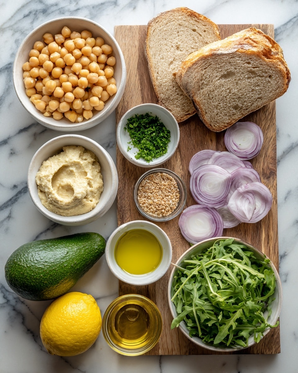 The image shows ingredients arranged on a white marbled surface. There is a white bowl filled with round, light yellow chickpeas near the top left. Next to it is a small white bowl containing a creamy light beige garlic hummus. Below the chickpeas is a small white bowl with finely chopped, bright green fresh herbs. To the right, there are two thick slices of light brown bread with a textured crust resting on a wooden cutting board. Below the bread on the cutting board are thin, pale purple slices of red onion. Two small cucumbers, dark green and smooth, are placed diagonally on the board below the onion. Near the bottom left, a whole dark green avocado sits next to a bright yellow lemon. Below the avocado is a small clear glass bowl with golden olive oil. On the right side, a white bowl filled with fresh, green arugula leaves occupies the space. Lastly, a small white bowl contains grainy, brownish mustard. The whole layout is neat and colorful, with natural textures and fresh ingredients, photo taken with an iphone --ar 4:5 --v 7